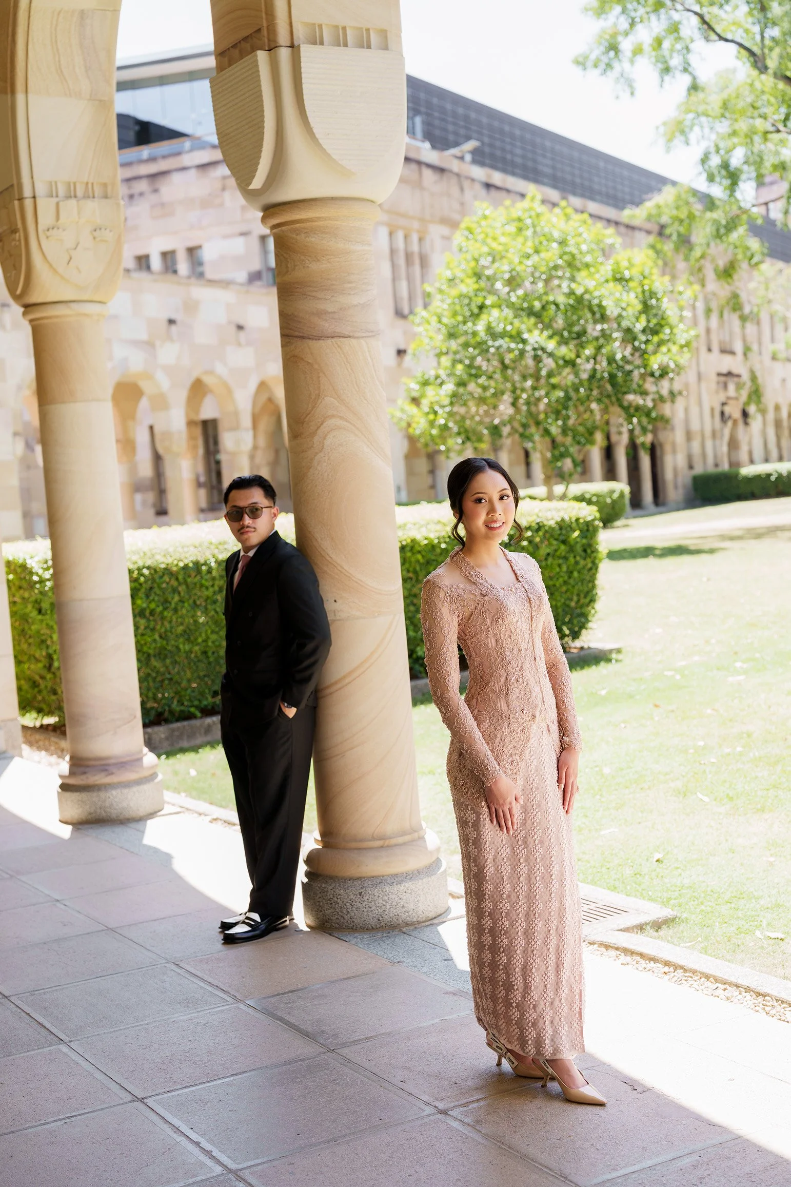 Aka back against the column look at the Brisbane wedding photographer Whistler and Bella standing with hands on side of the body