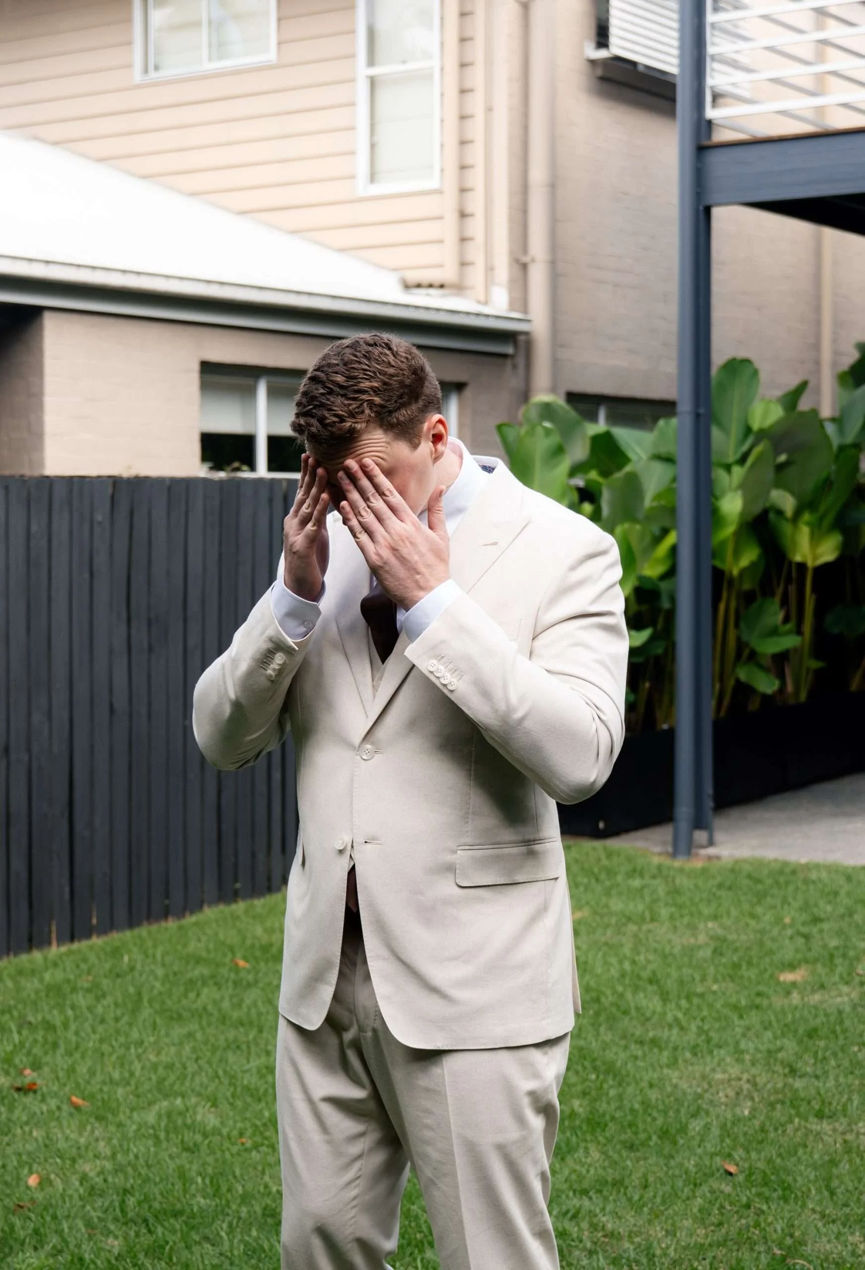 Groom rubbing his eyebrows before wait for the first look