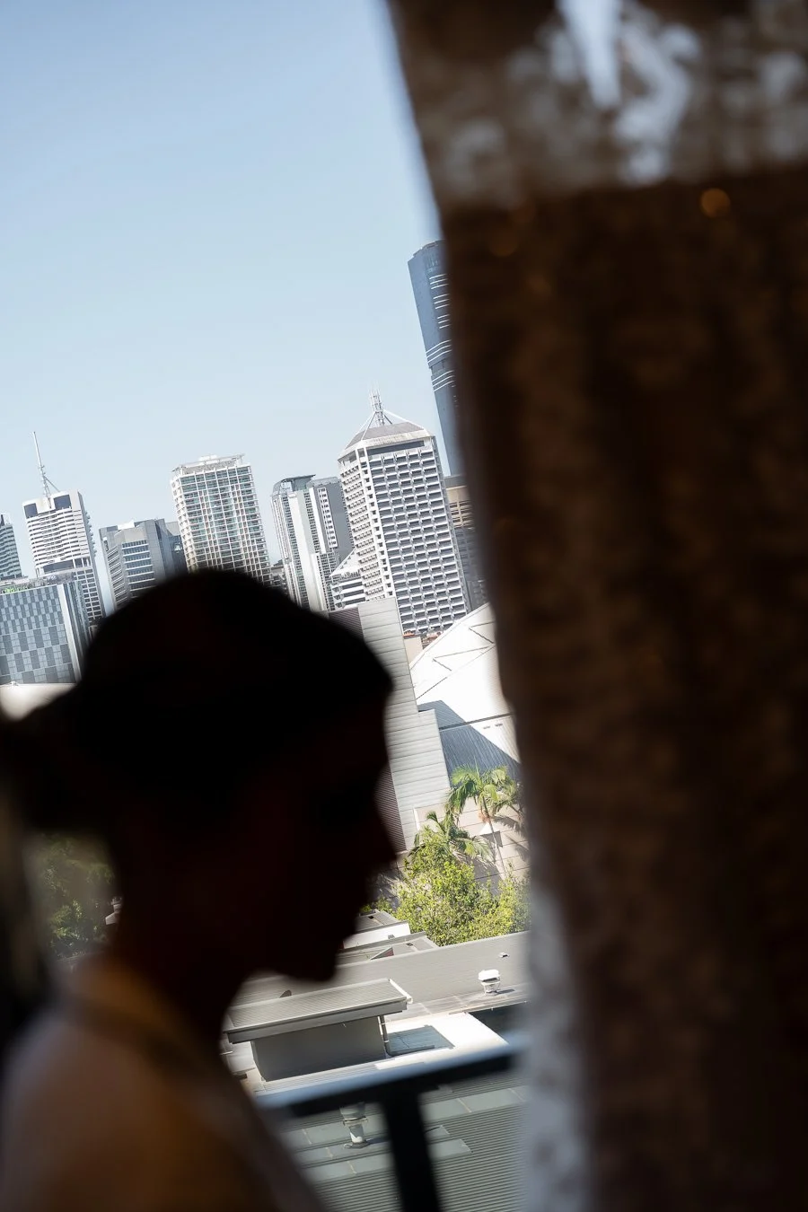 The bride in the foreground, with the Brisbane city skyline in the background