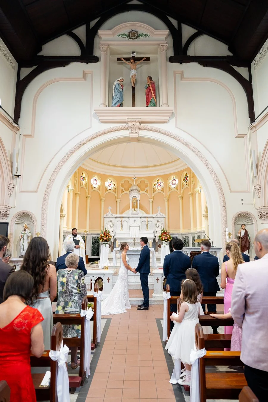 bride and groom holding hands facing to each other during the wedding ceremony