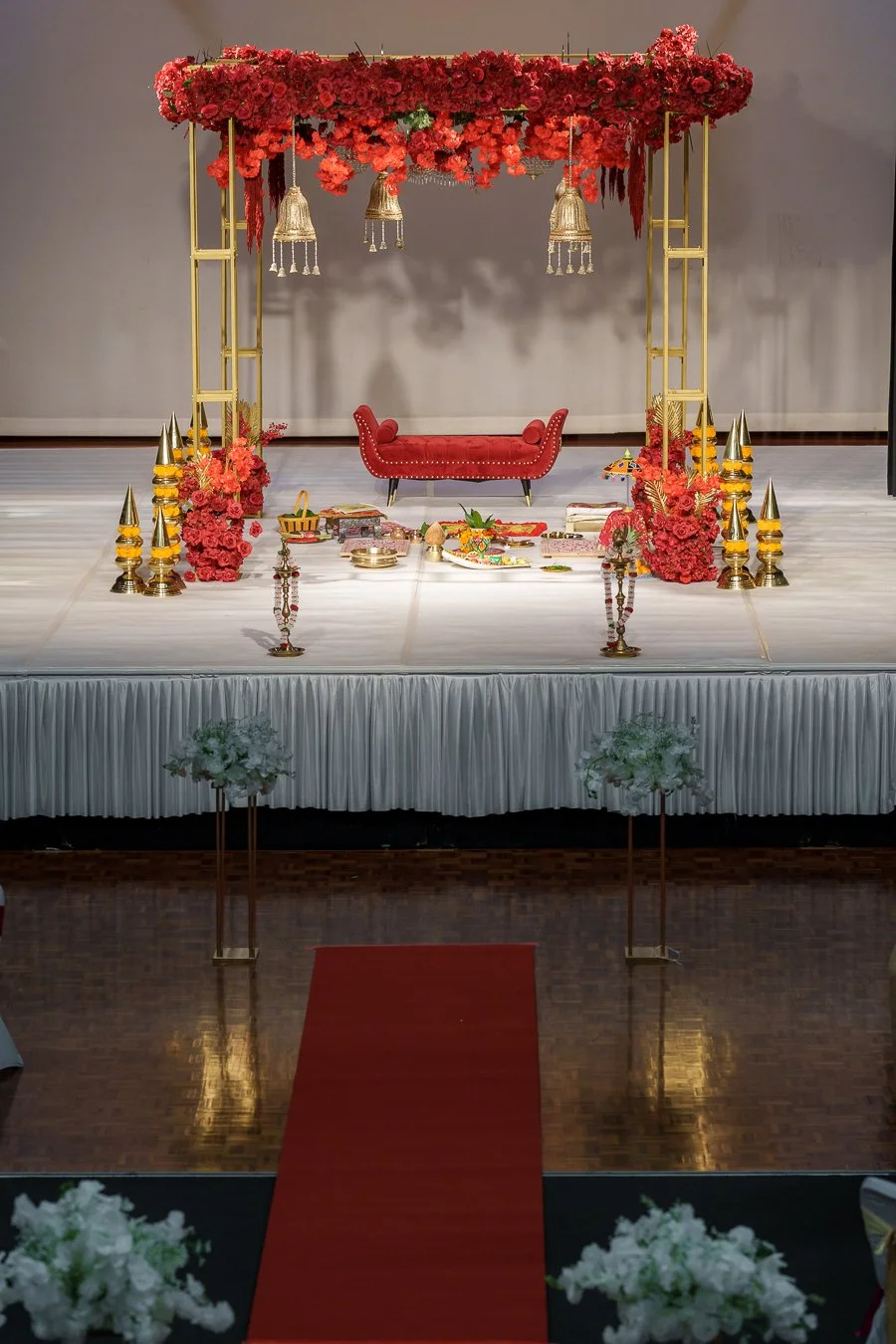 Amrita and Casey's decor, flower arch, decor and celebration tools on the stage