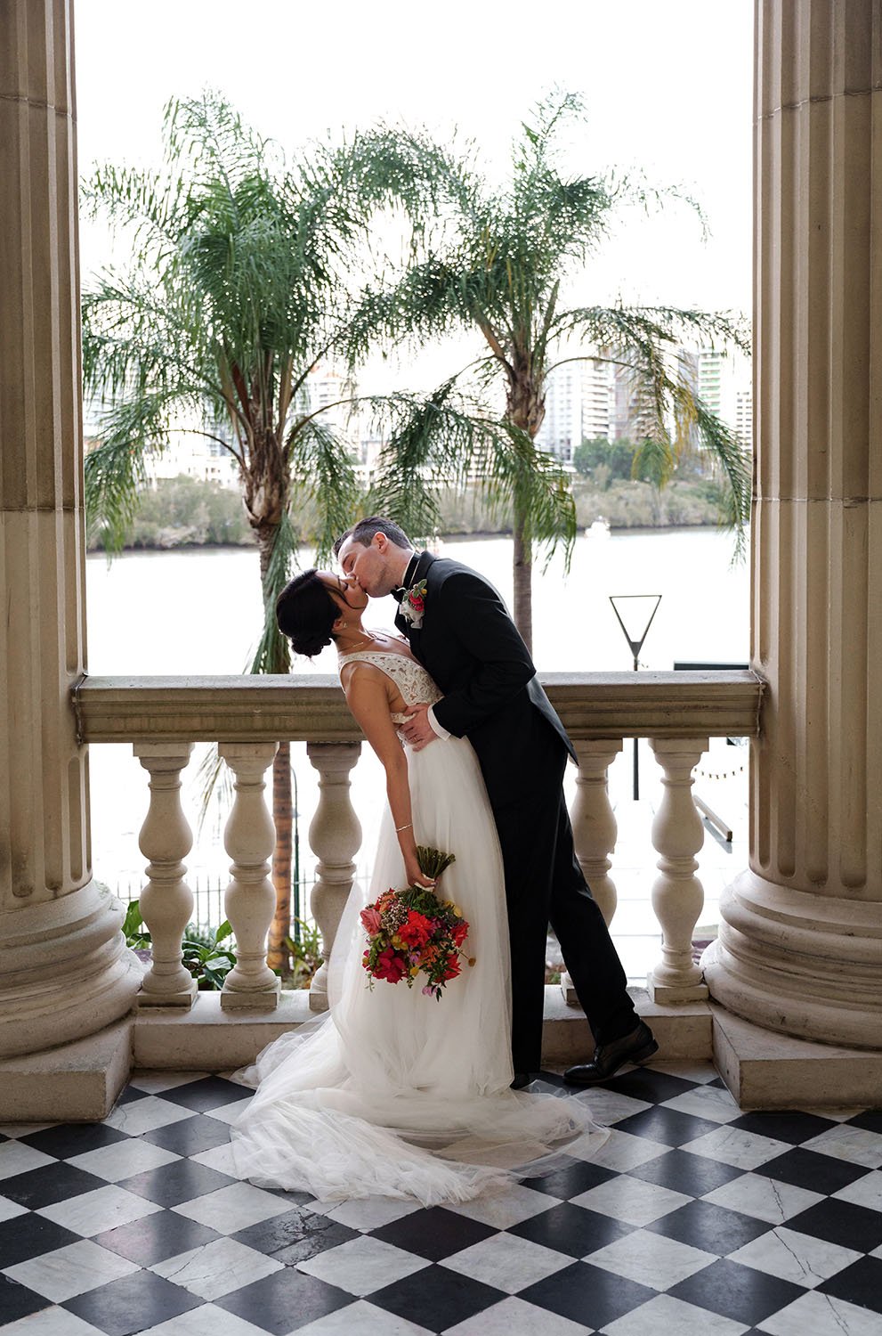 groom Cliffe kissing bride Nori with dipping
