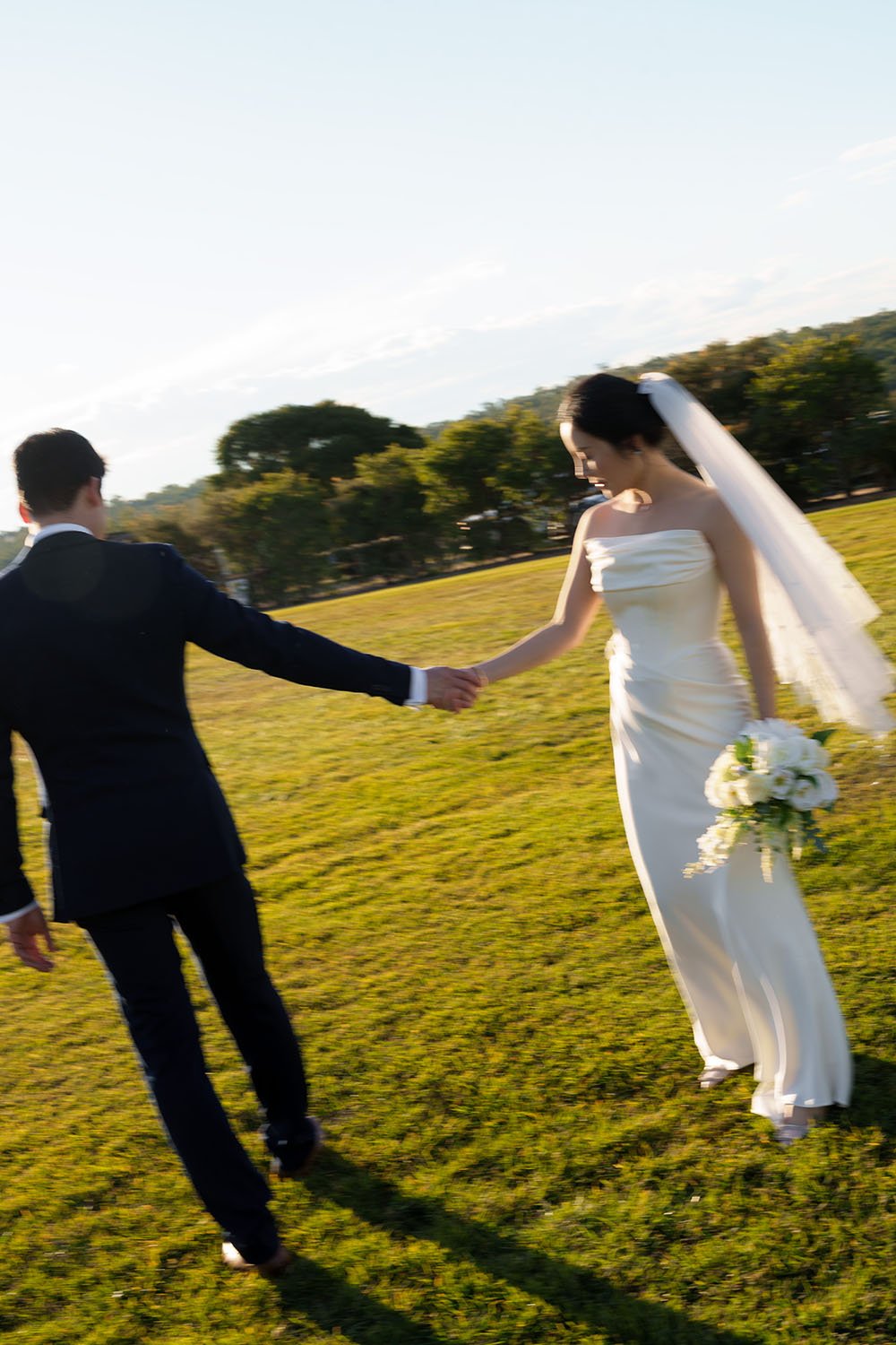 straight arm hands holding while bride Flora look to their hands
