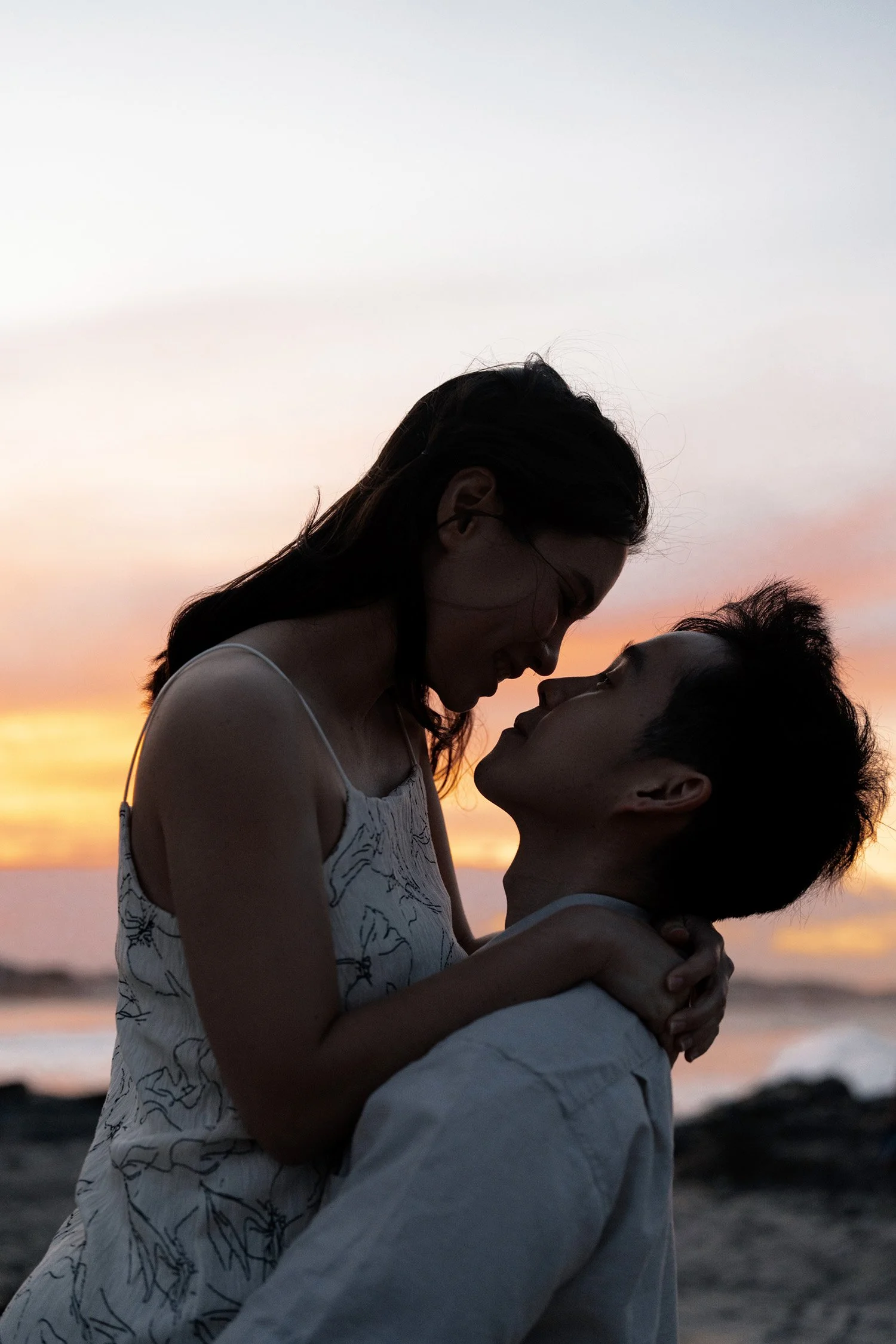 Paul holding Krystel up and they nose touching nose in Currumbin Rock