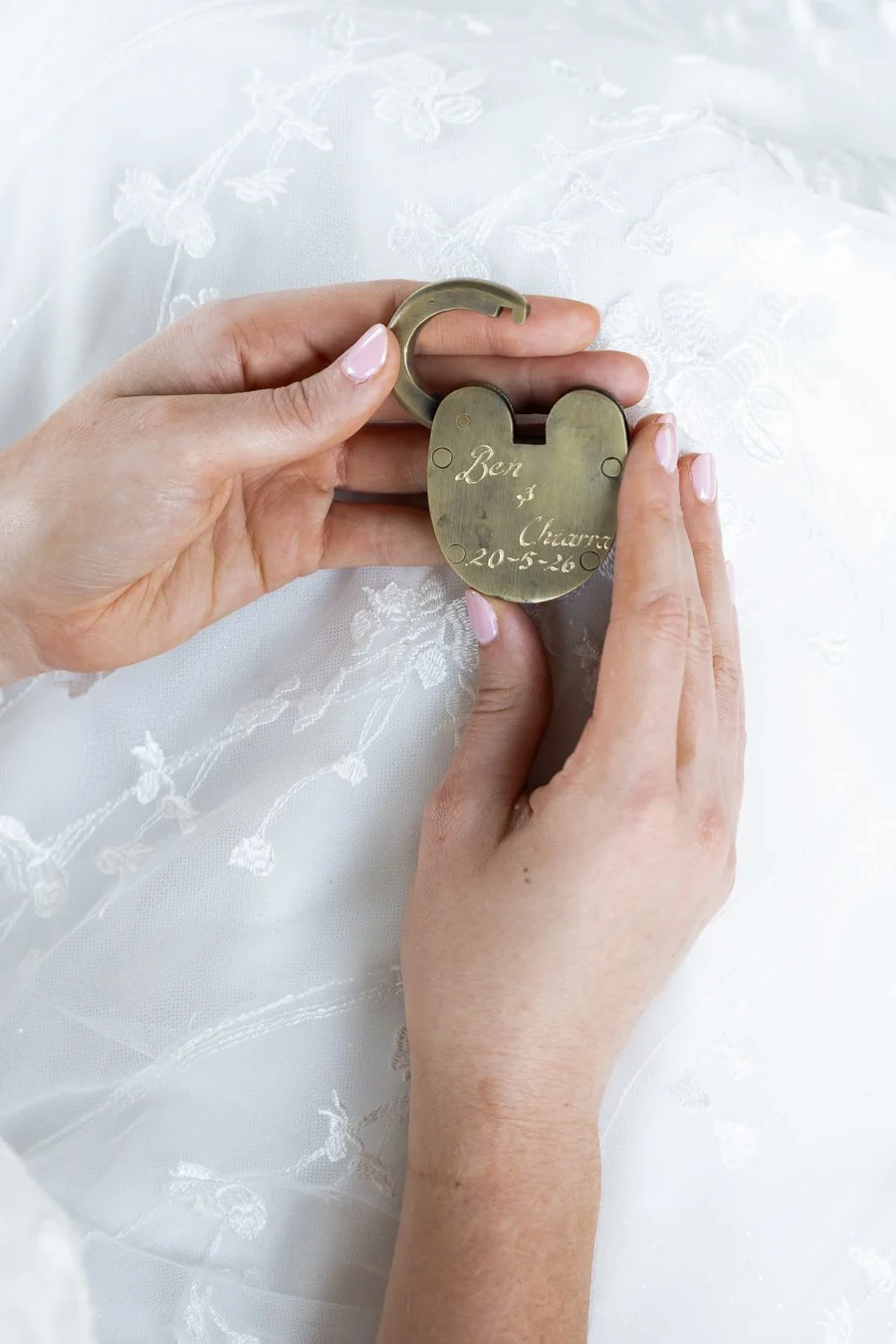 bride Chiarra holding a chain with letter on it