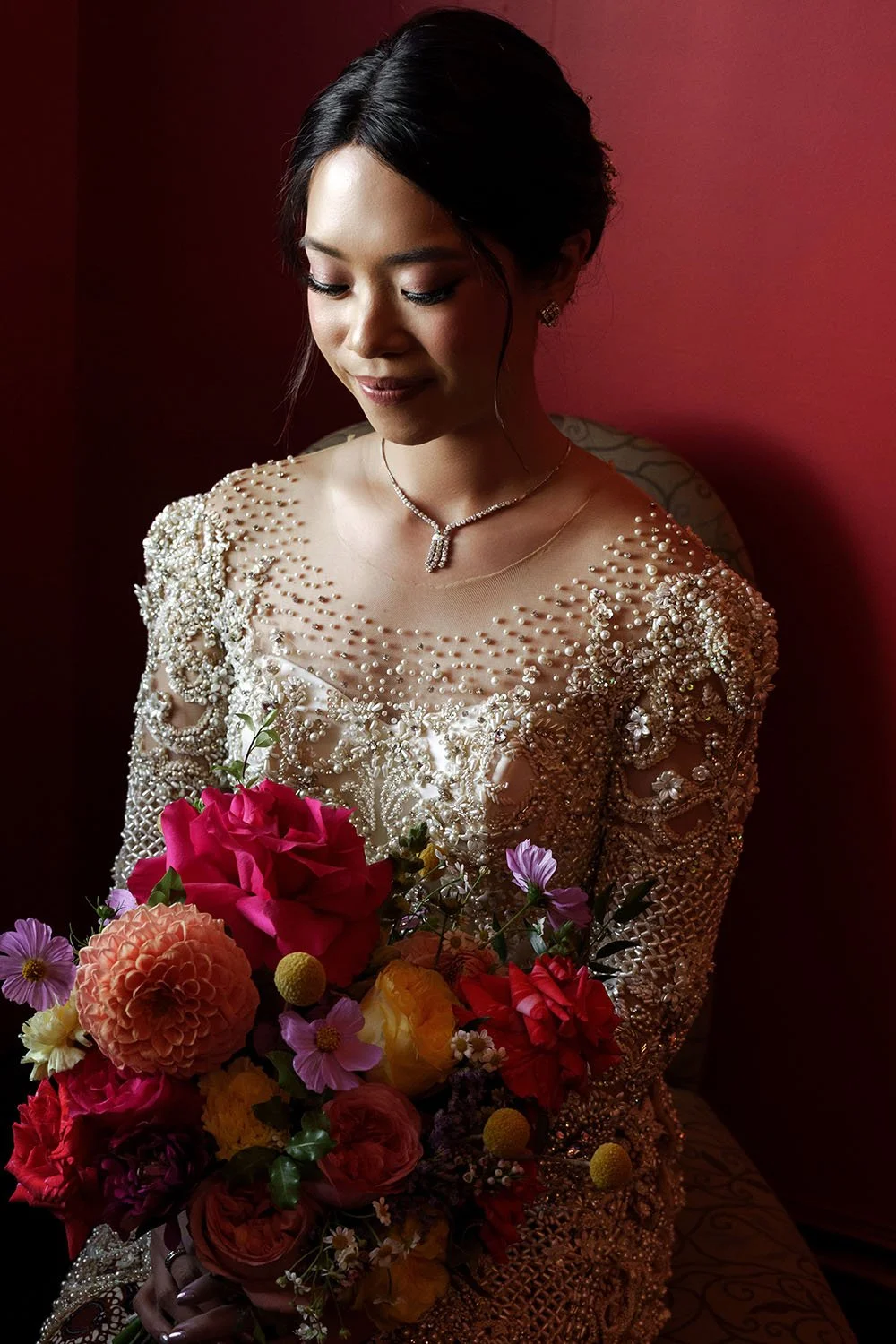 bride Nori sitting on the chair and next to the window light