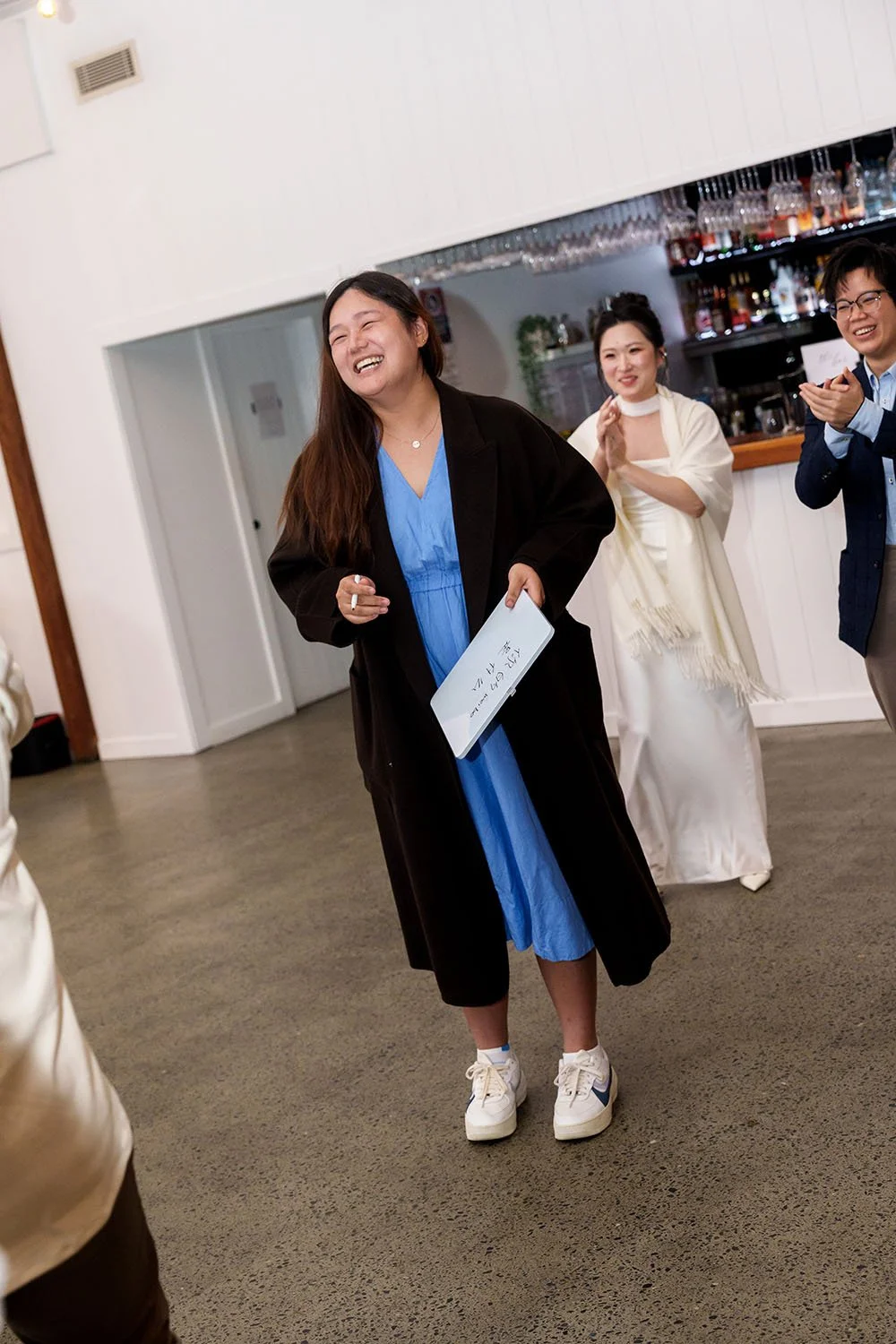 a lady laughing when holding a white board