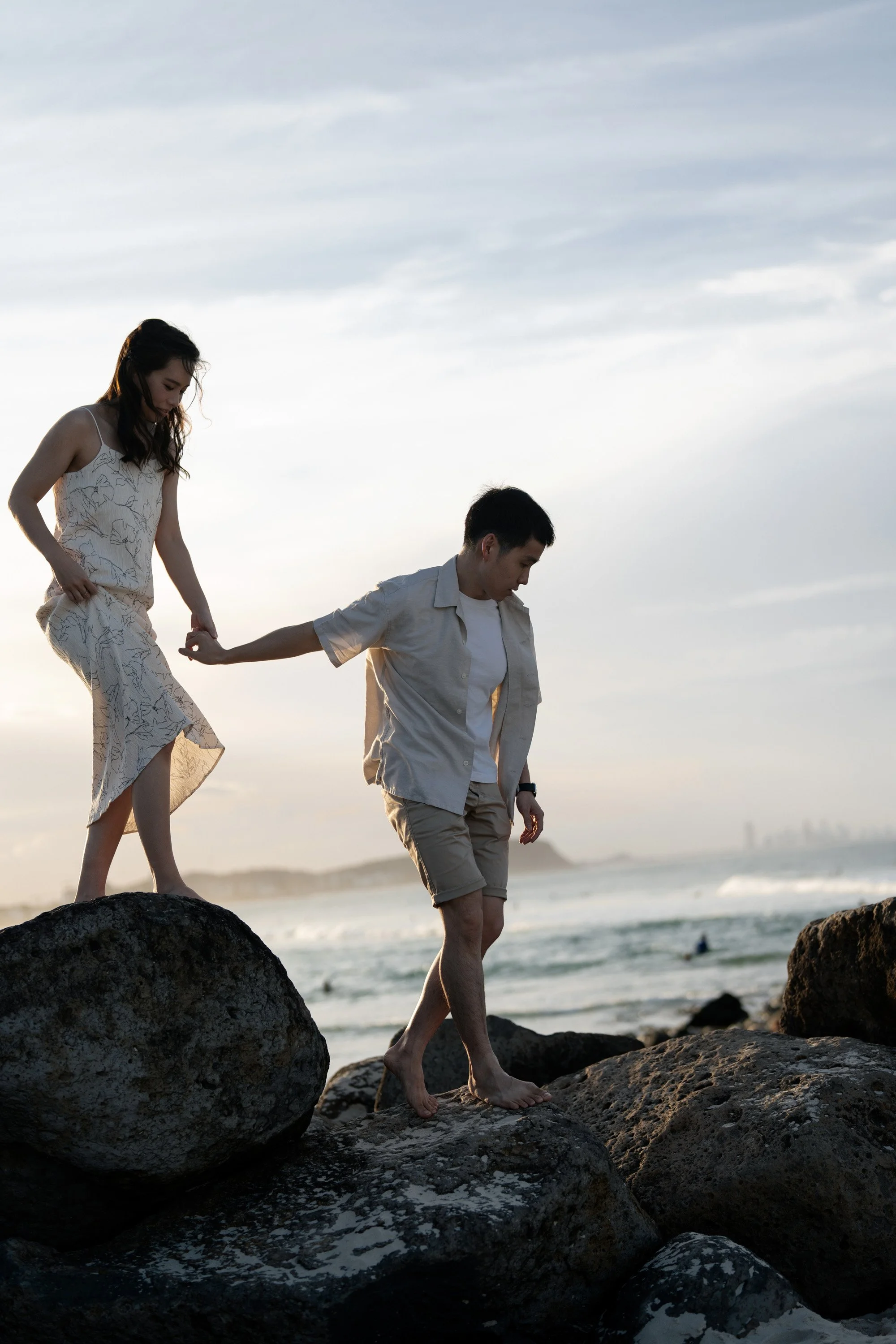 Paul holding Krystel's hand walking on the top of the rock in Currumbin Alley