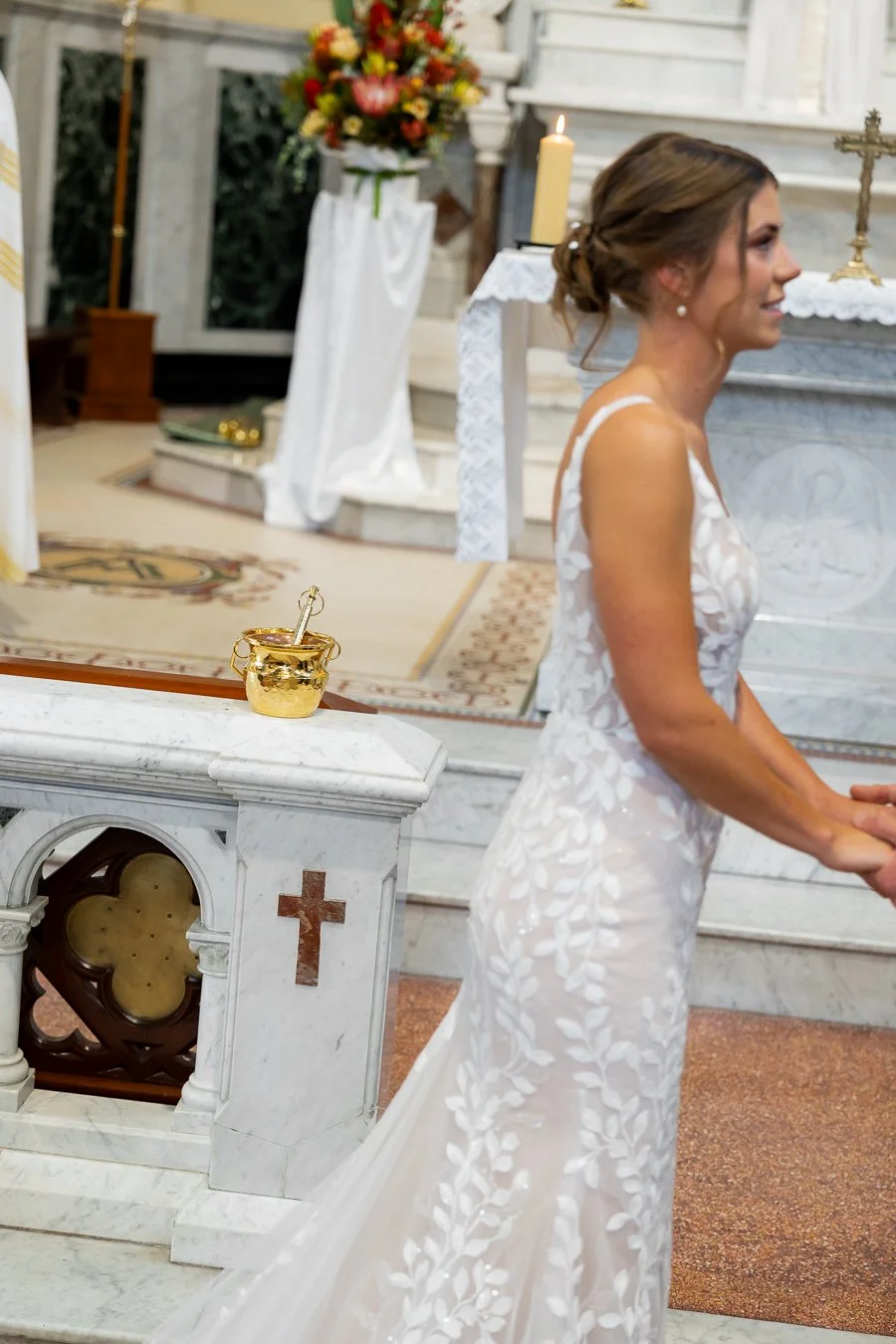 The holy water is placed on the railing, ready to be sprinkled on their rings later.
