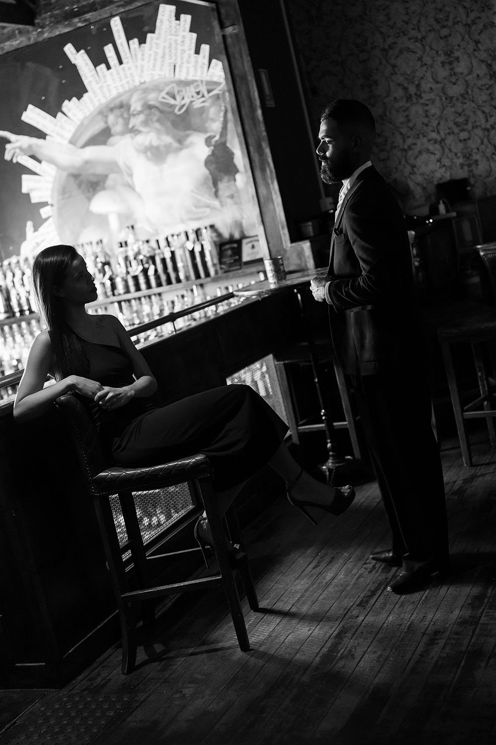 Jasmin sitting on the stool and Jay standing in front of her