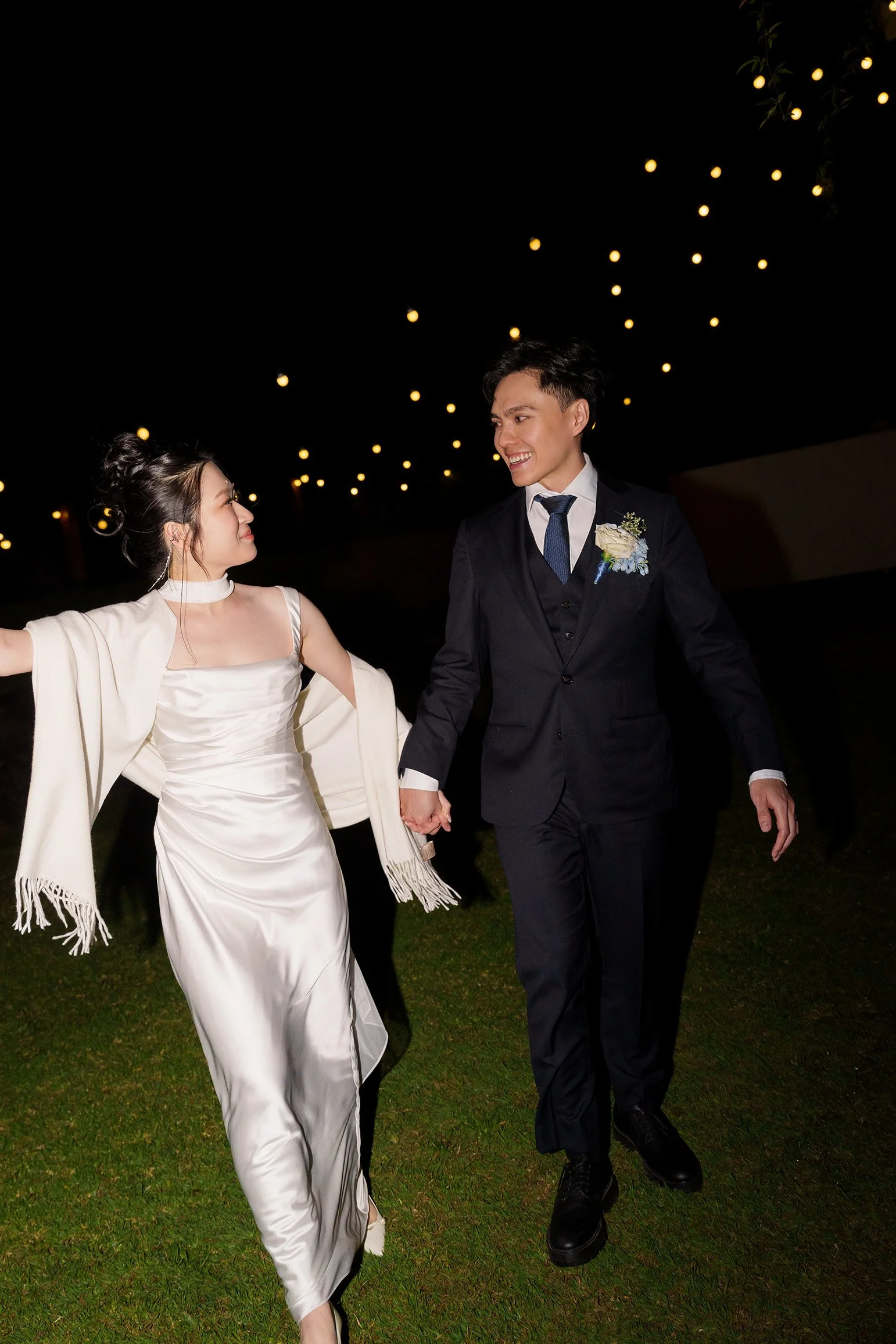 Michael holding Lisa's hand walking towards to the Brisbane wedding photographer Whistler Li  with a direct flash to them