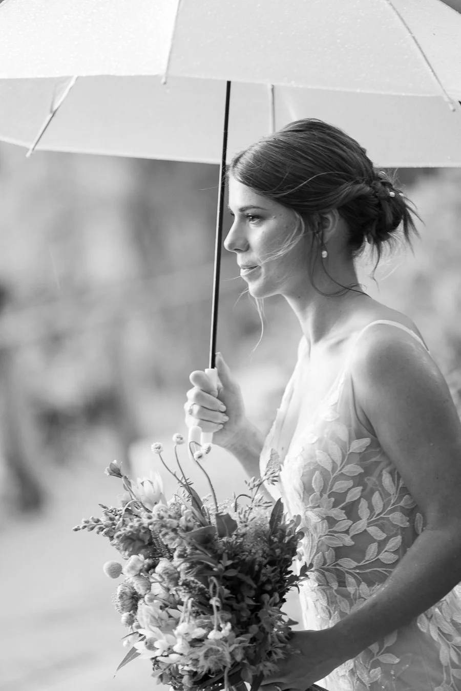 bride Sonya holding a white umbrella look stright ahead