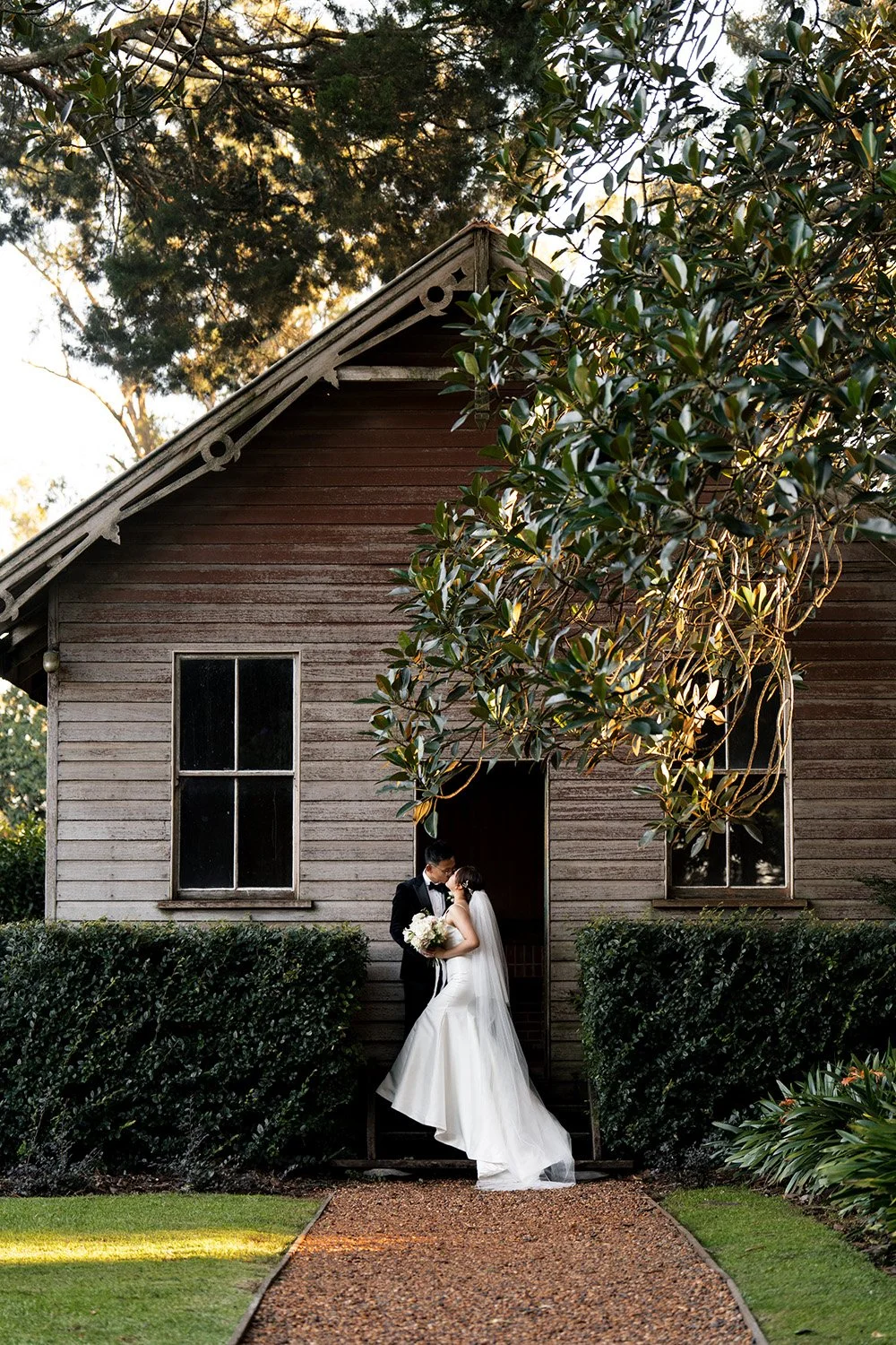bride and groom kissing in front of the house in Gabbinbar Homestead