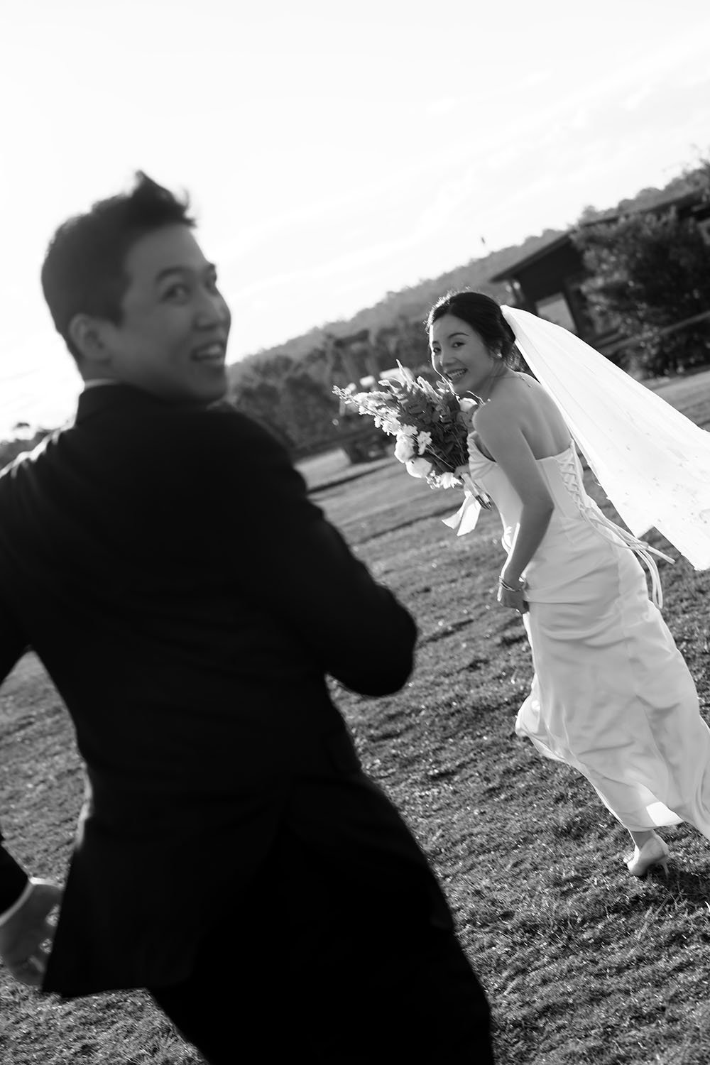 Eric and Flora running together while look back to the Brisbane wedding photographer Whistler Li