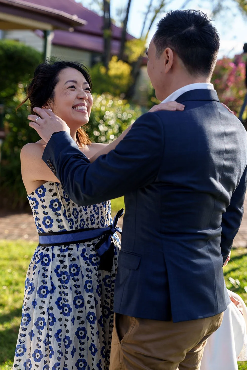 Eric's sister touching his husband's face