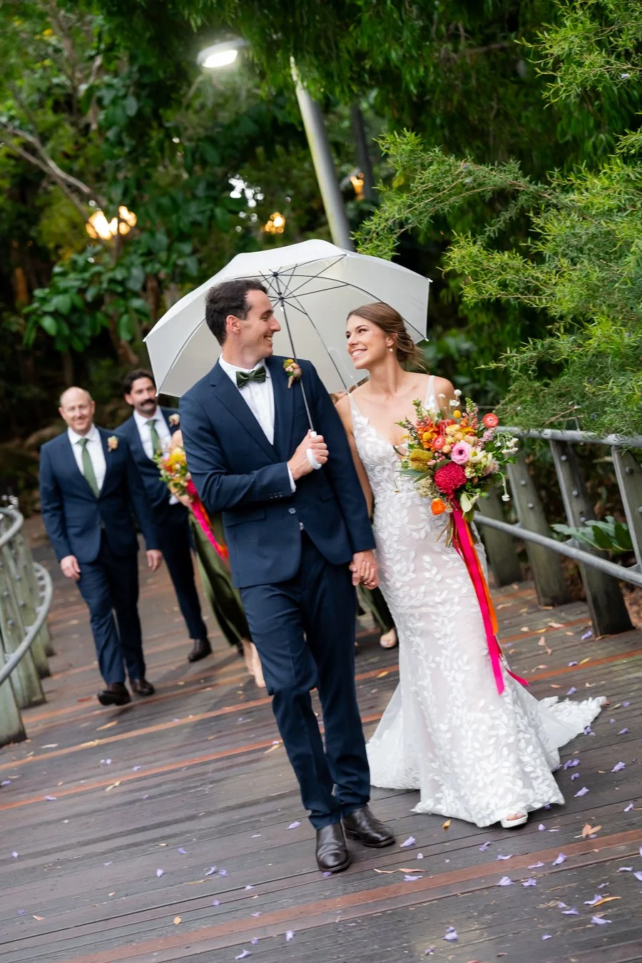 bride and groom leading bridal party walking towards to the camera