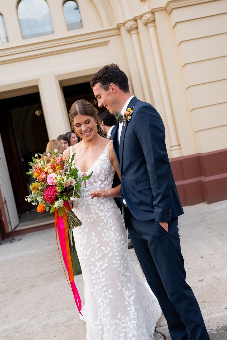 bride Sonya and groom Giordan look at her wedding rings