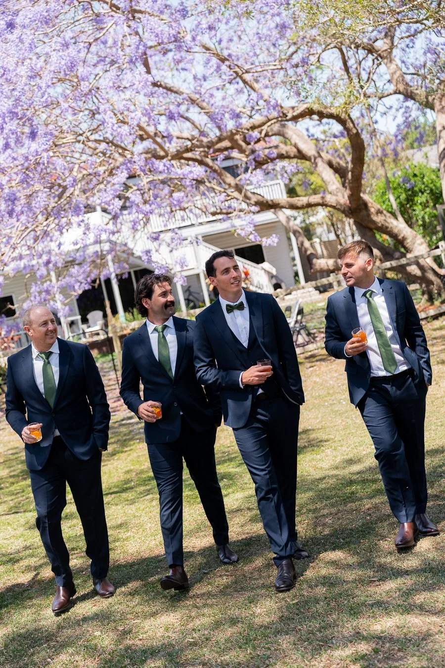 The groom and his groomsmen walked toward the camera