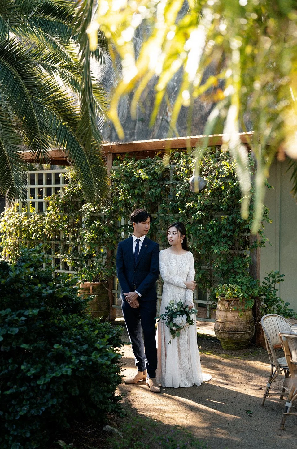 bride Leo and bride Cassie back to back and look at each other in Wilson Outlook Reserve