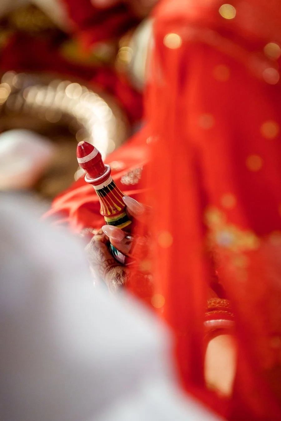 red prey bottle holding on Amrita's hand