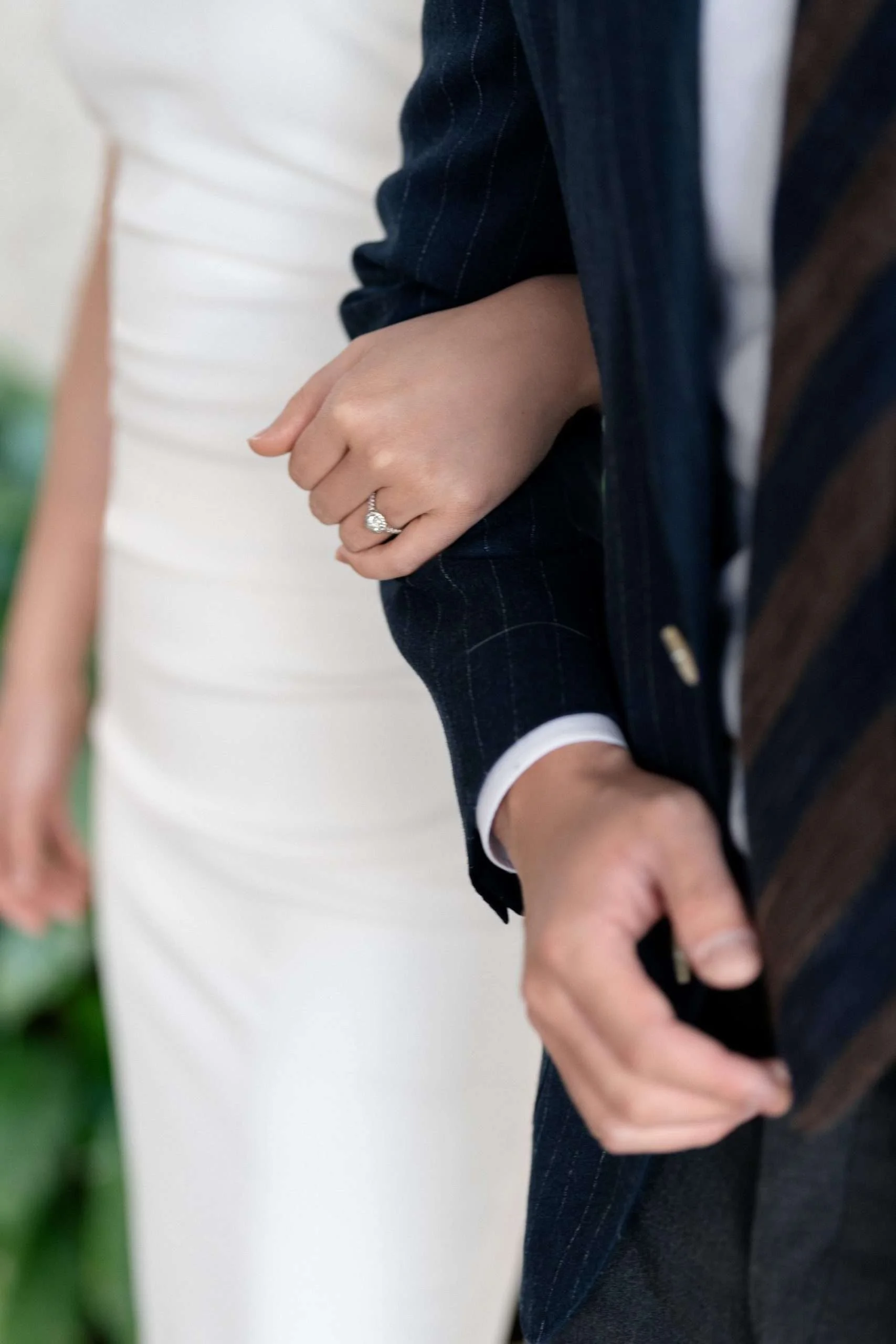 Kath's engagement ring glistening on her finger as she holds Dave's arm, symbolizing their connection and the promise of their future together