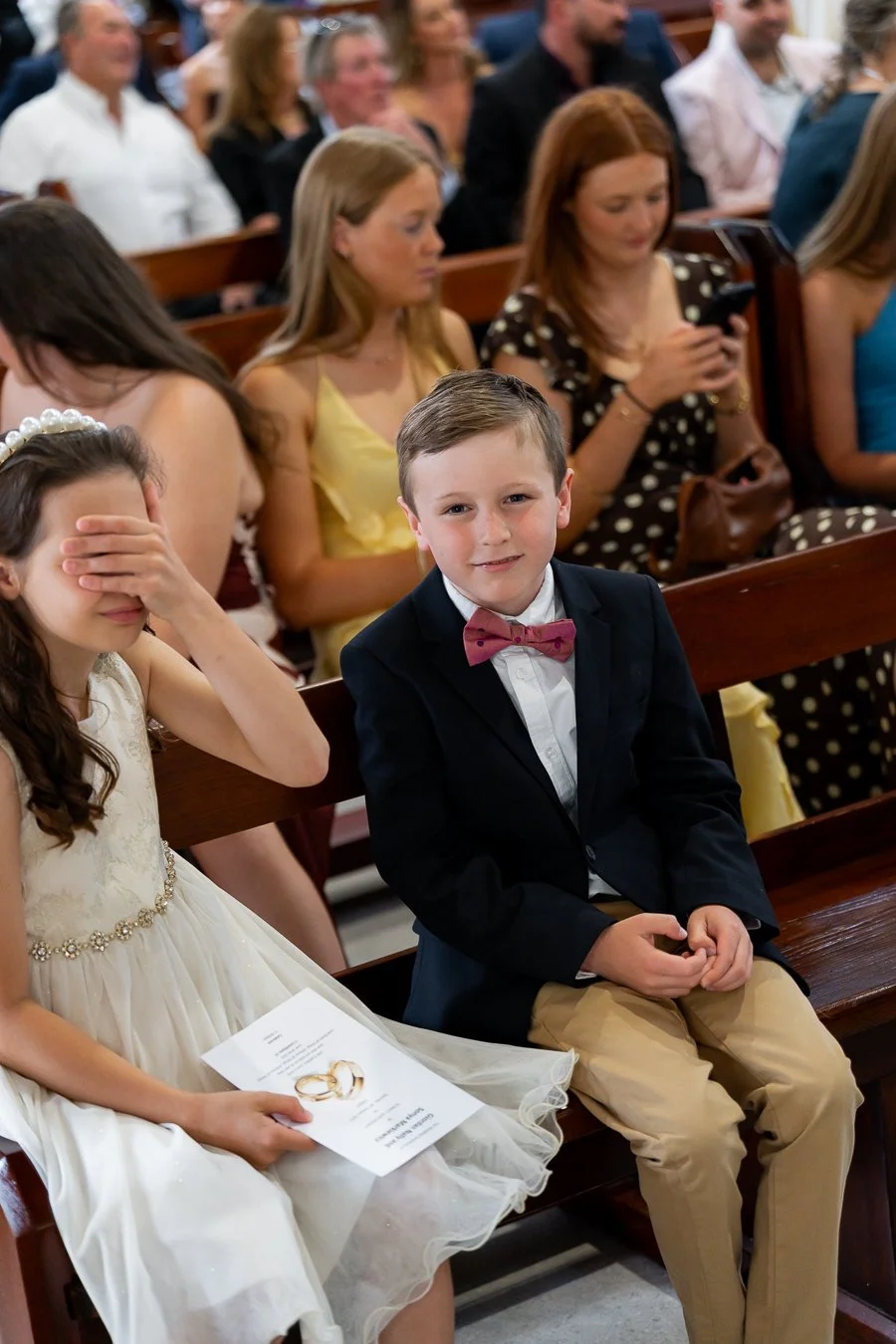 The little girl covered her eyes with her hands, while the little boy looked at the Brisbane wedding photographer.