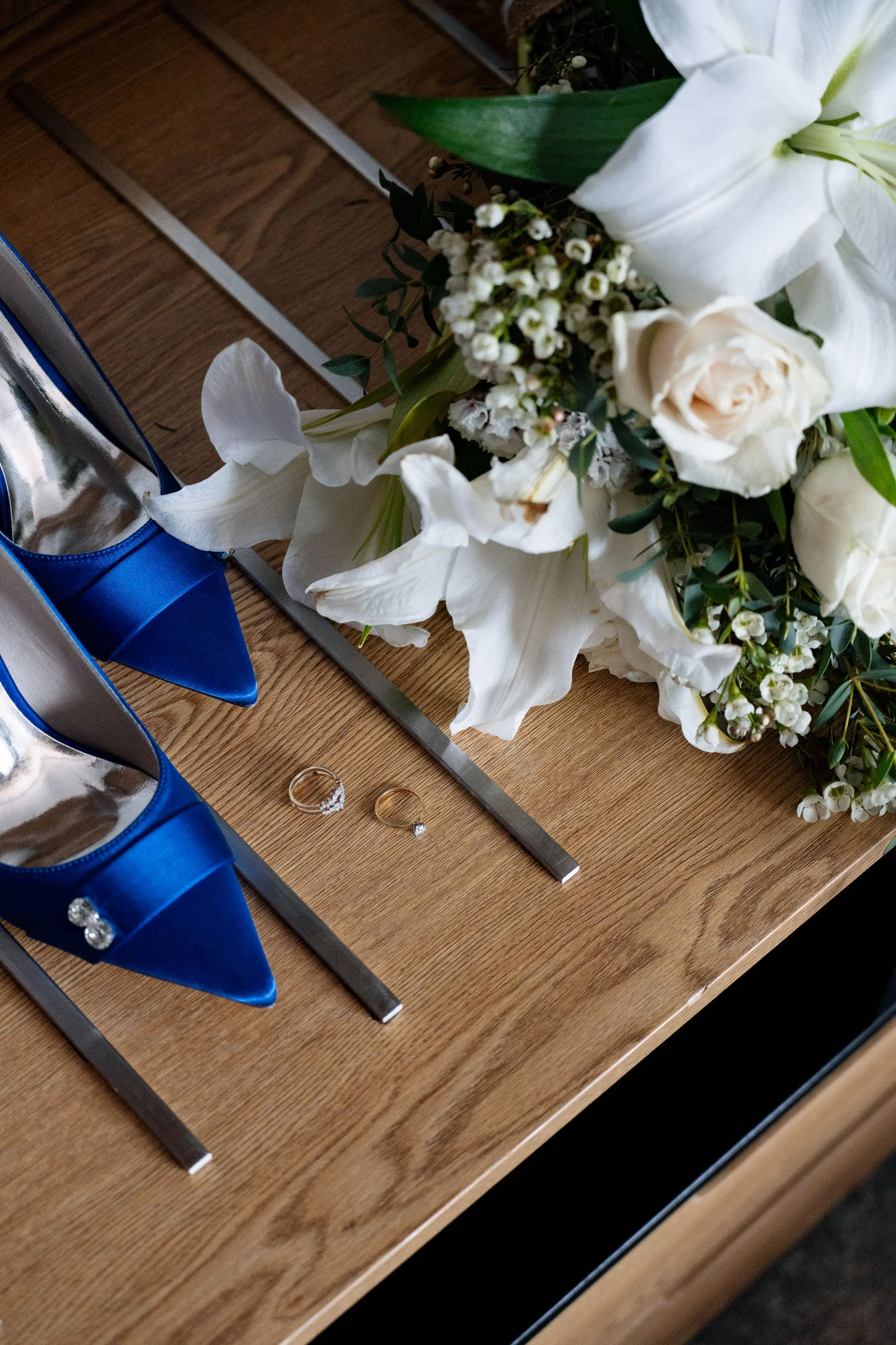 Bridal high heels, wedding ring, and bouquet placed together, showcasing a beautiful collection of the bride's wedding day essentials, each symbolizing elegance and love