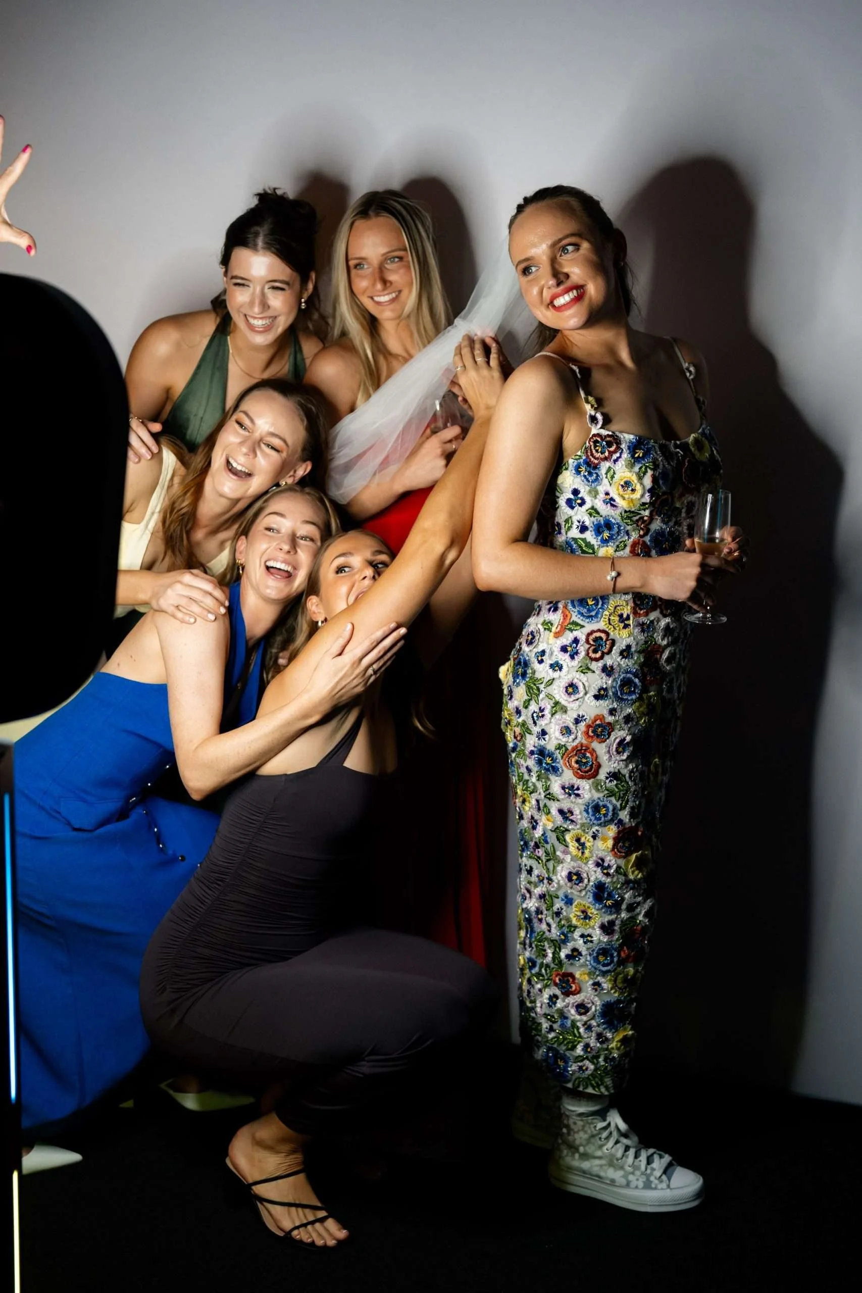 7 girls pose to a Photo Booth for a photo