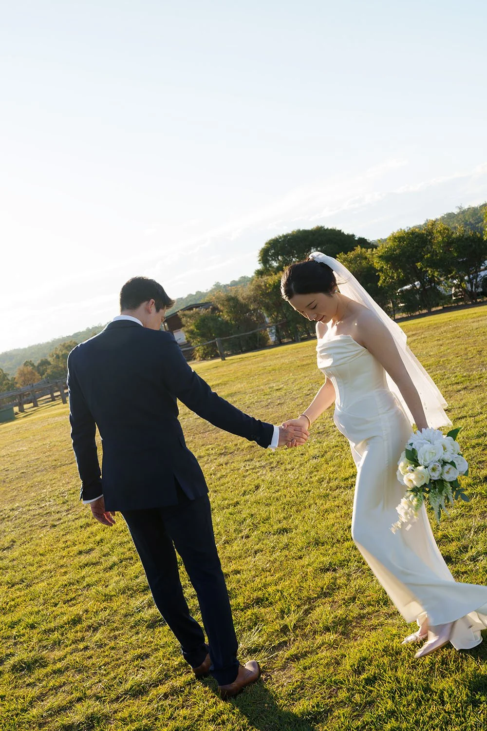hands touching keep heads down, and the bride Flora walking towards to Eric