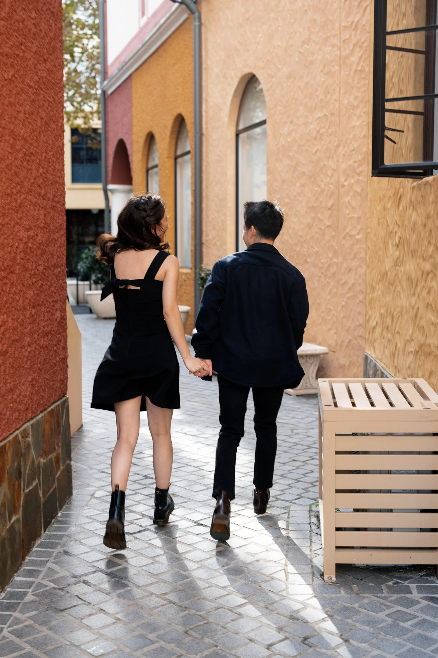 Krystel and Paul running away from the camera when holding their hands, Brisbane engagement photography