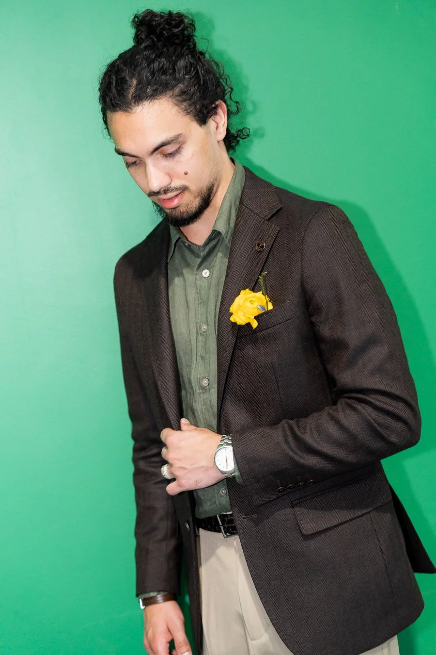 Junaid holding his jacket and look down