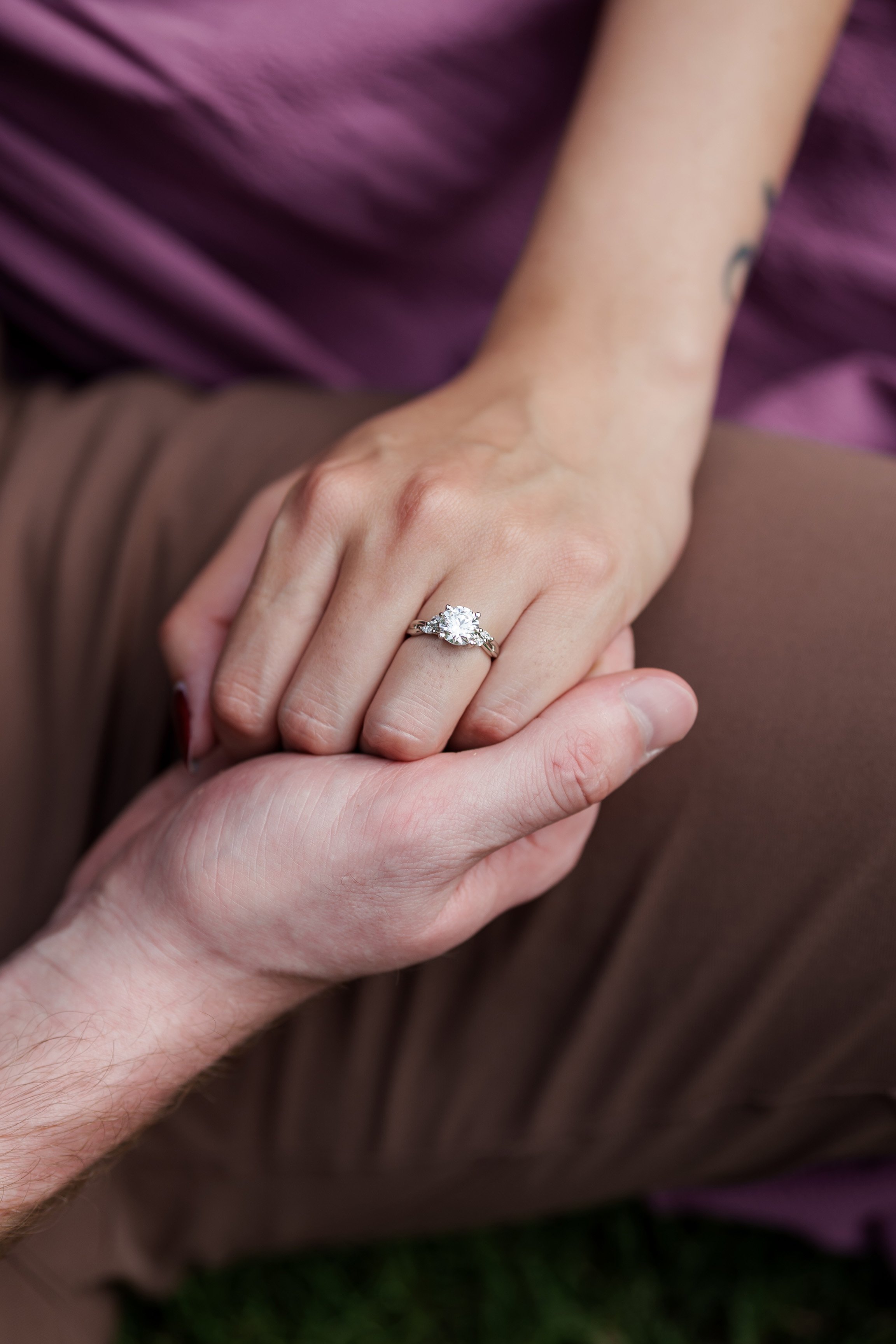 hands holding and engagement ring