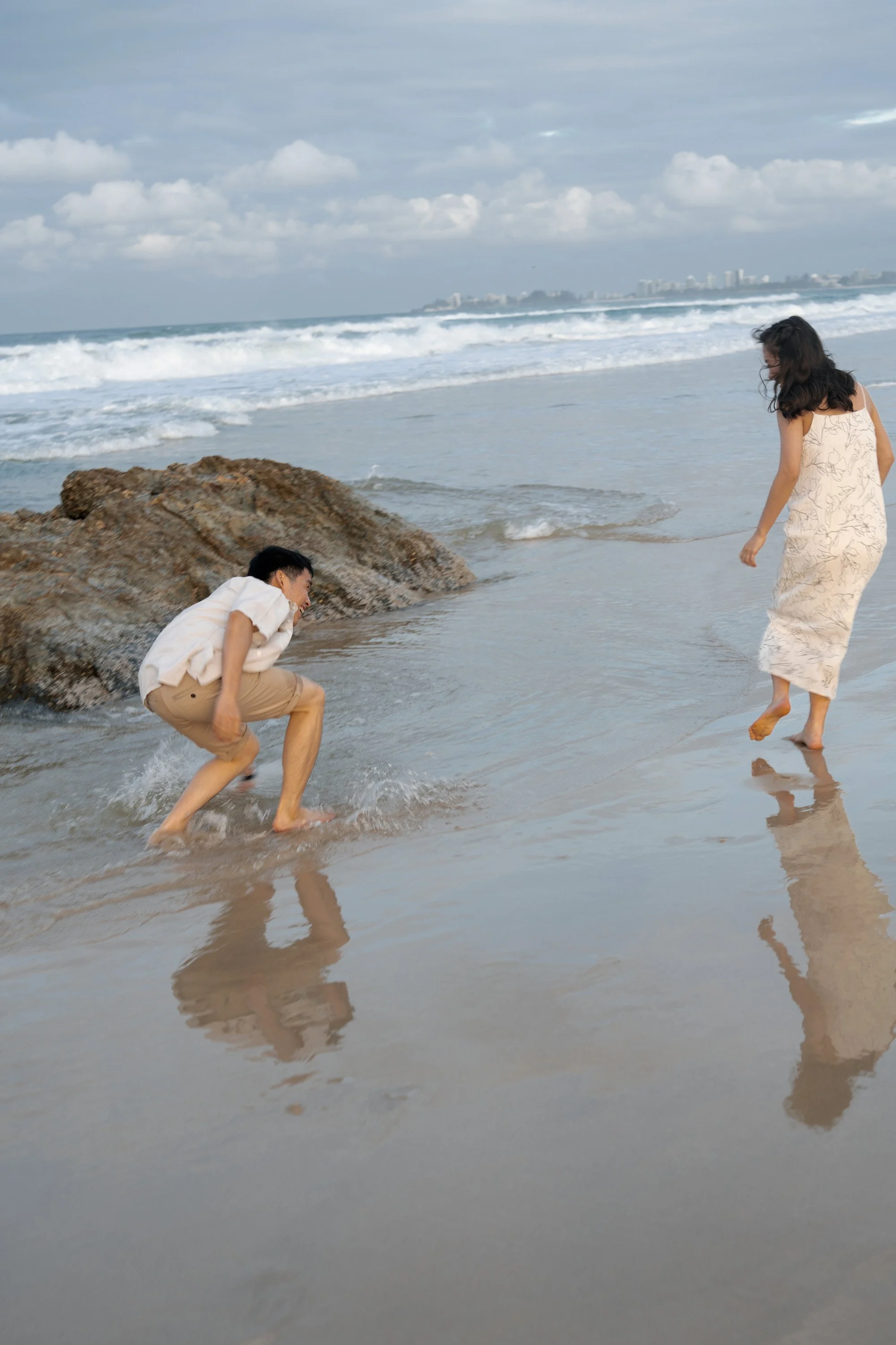 Paul scoops water to Krystel with his hand in Currumbin Rock