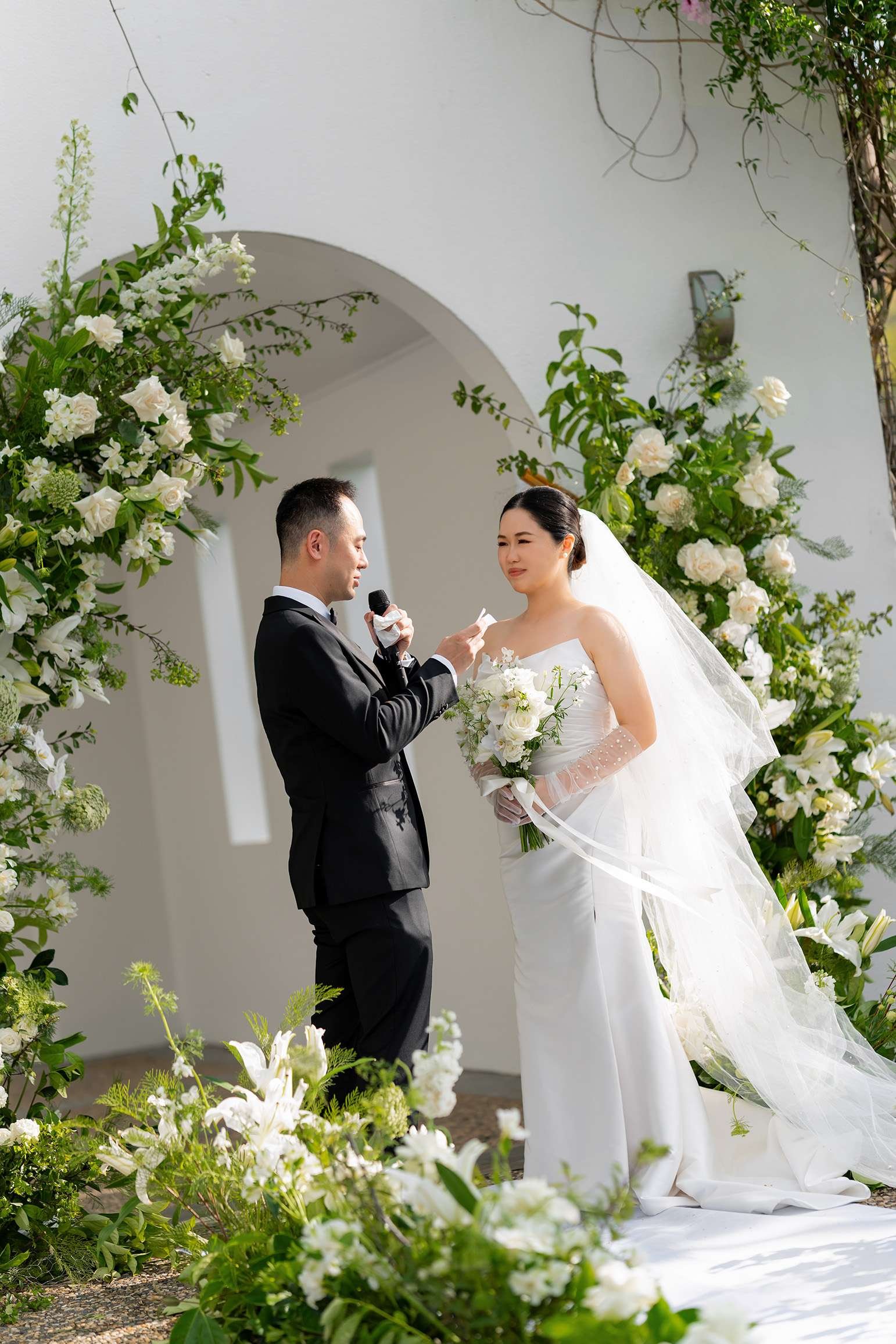 Alex speaking on a mic reading his vows