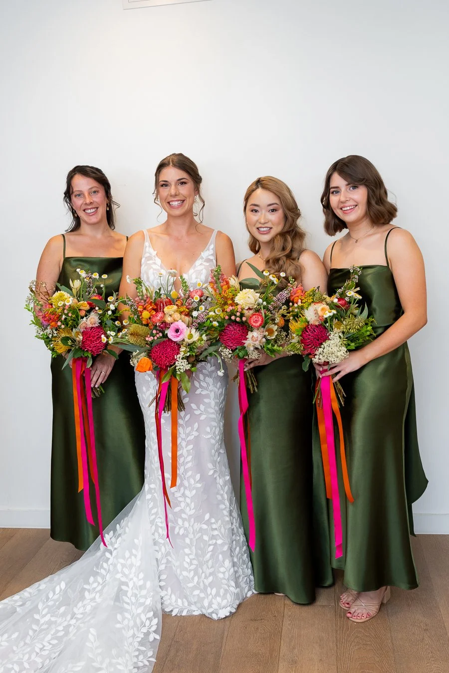 The bridesmaids and the bride held their bouquets at the same level, looking toward the Brisbane wedding photographer Whistler Li