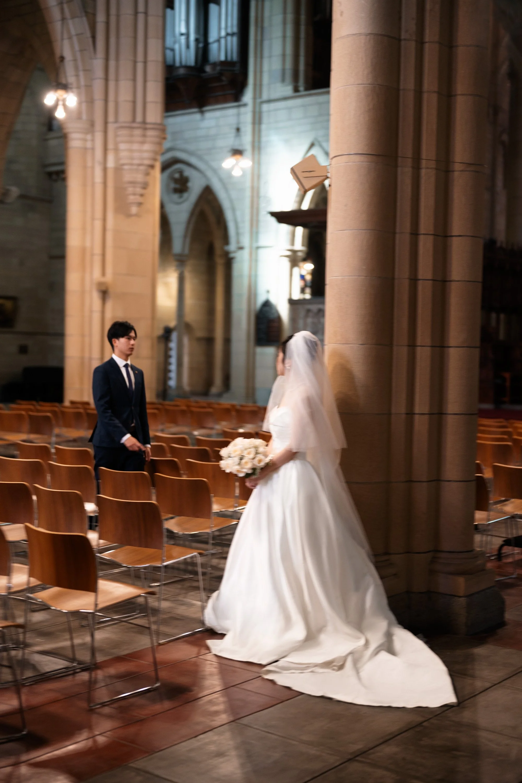 bride and groom walking towards to each other with motion blur in St John's Cathedral in Brisbane