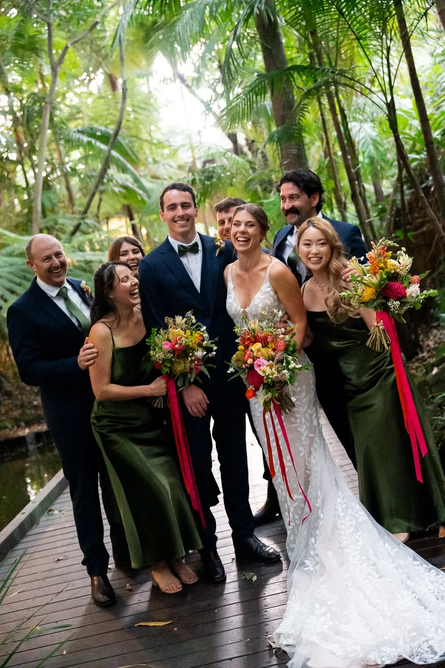 bridal party happily hug each other and smile at the Brisbane photographer Whistler Li
