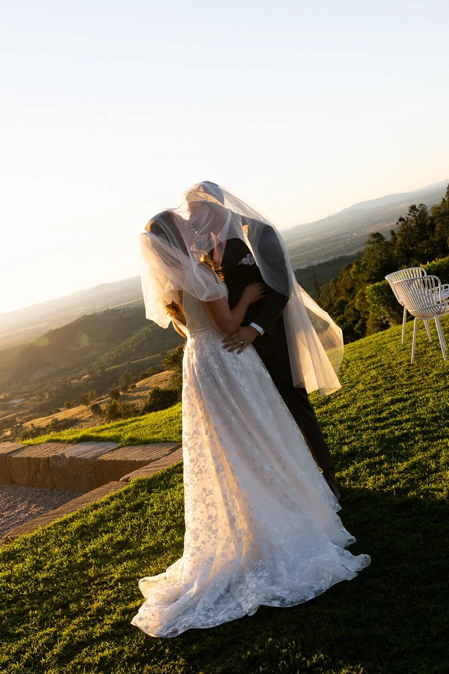 Ben and Chiarra kissing under her veil