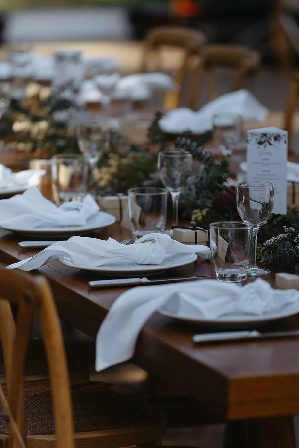 reception decor on the table, glass, cutlery, plates and flowers