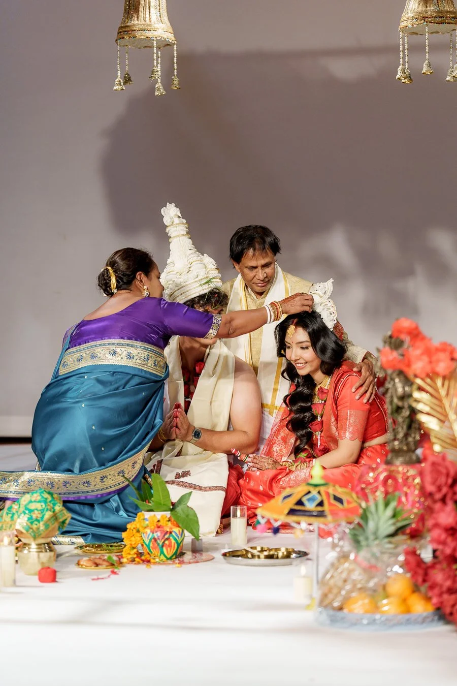 Amrita's aunty making a good wish to them and her uncle holding her from back