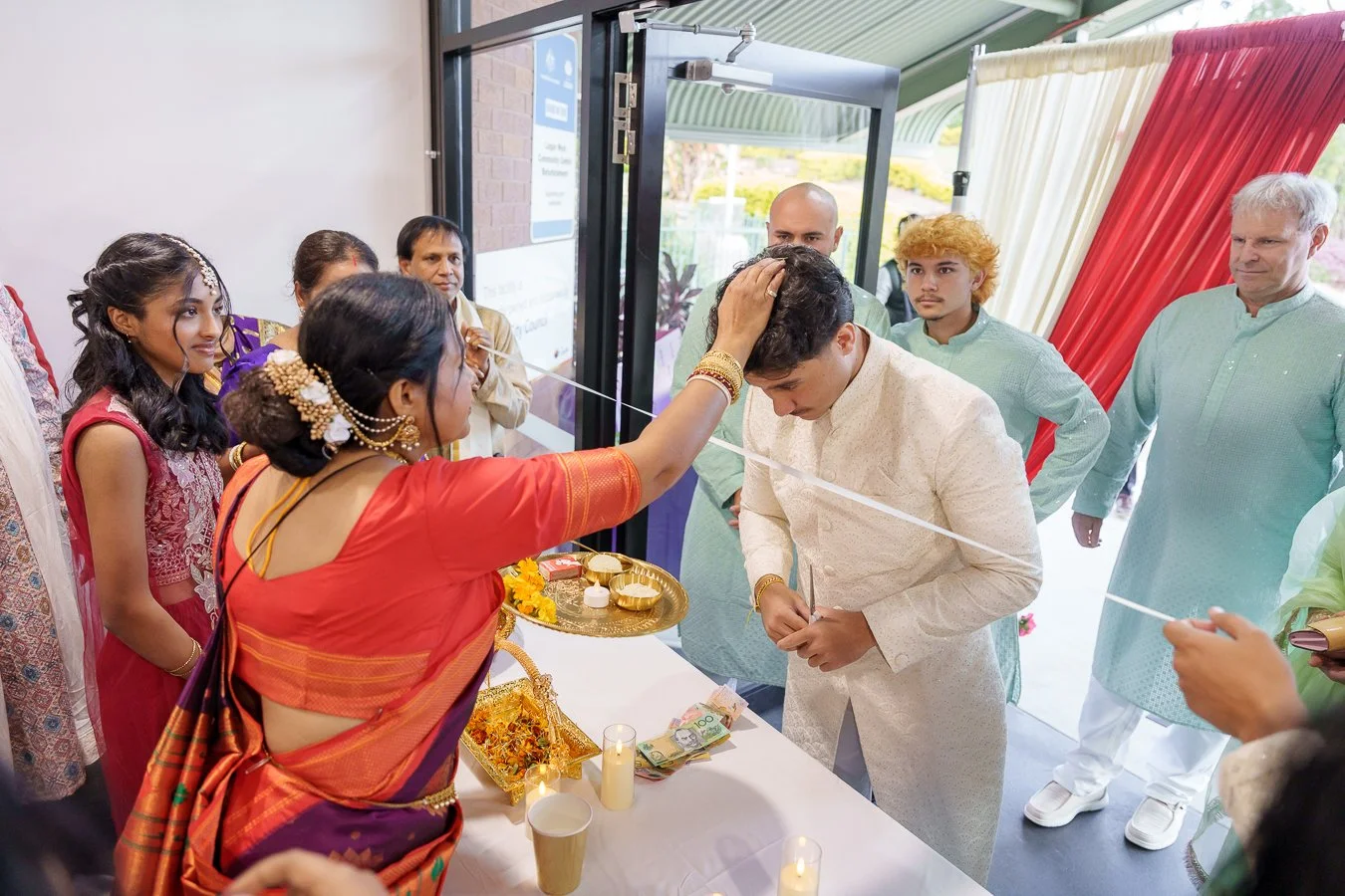 Amrita's mum touching Casey's head