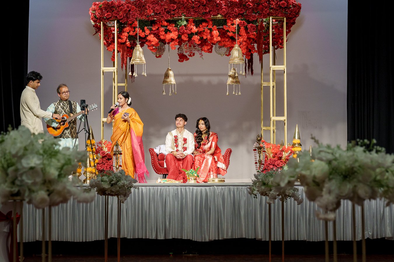 Amrita and Casey sitting look at the singer perfomence