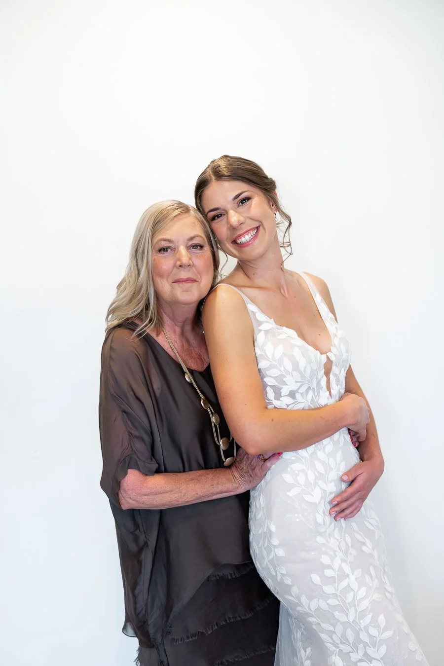 bride Sonya's mum holding her from behind