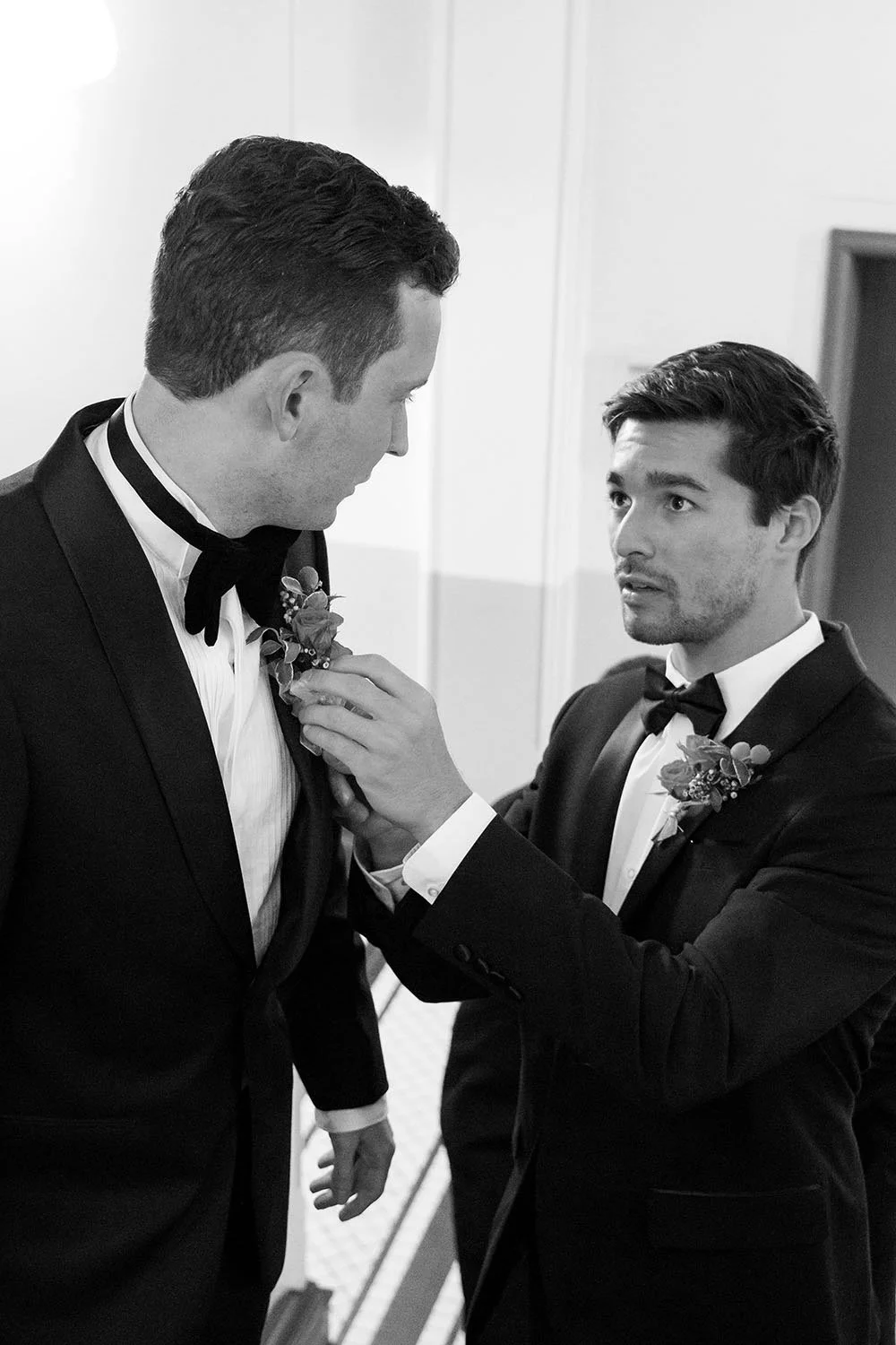 groom Cliffe's best man put on the pocket flower for him