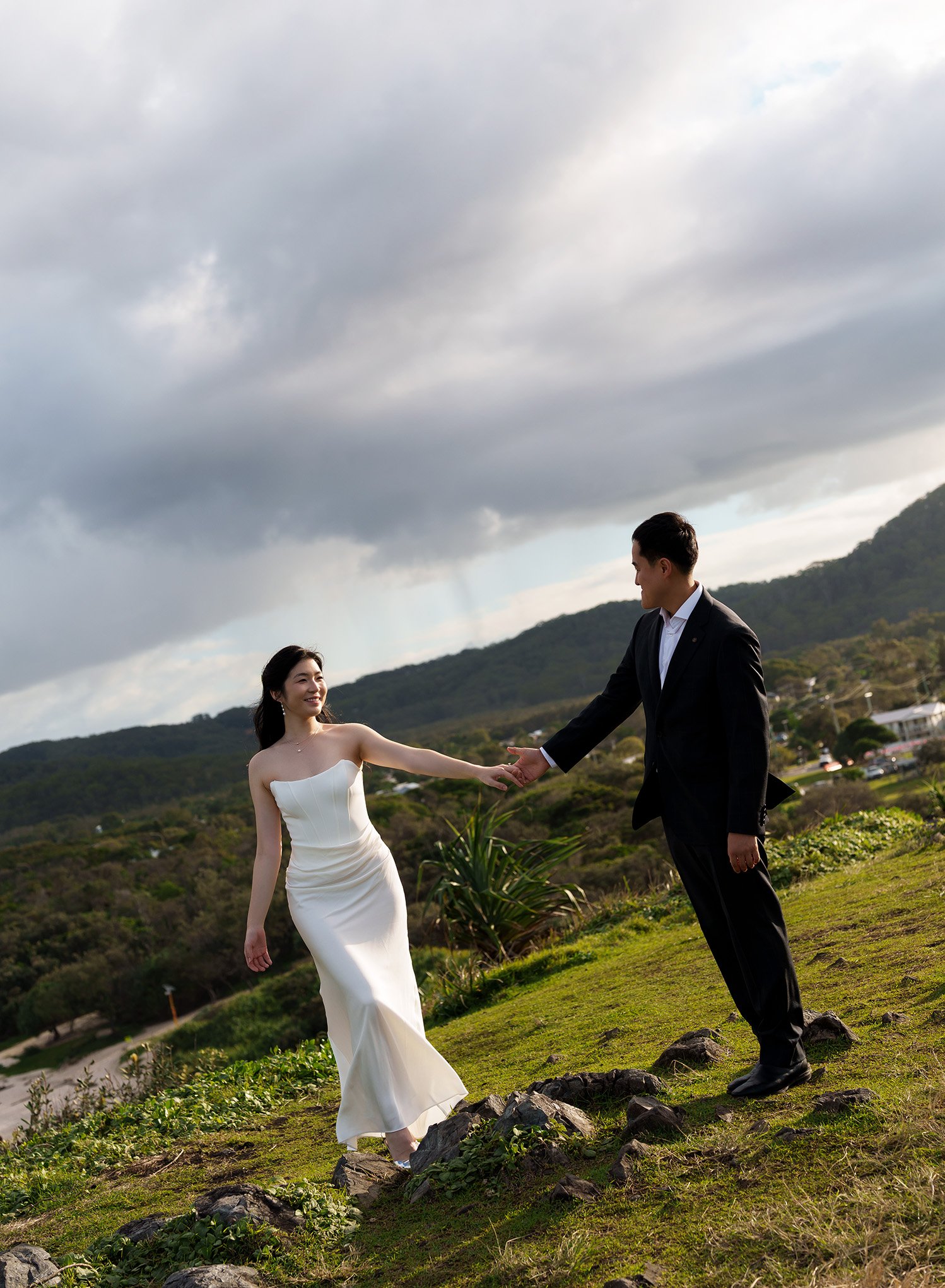 Silva and Margaret with finger touching, eyes look each other, stand there and raining cloud behind them