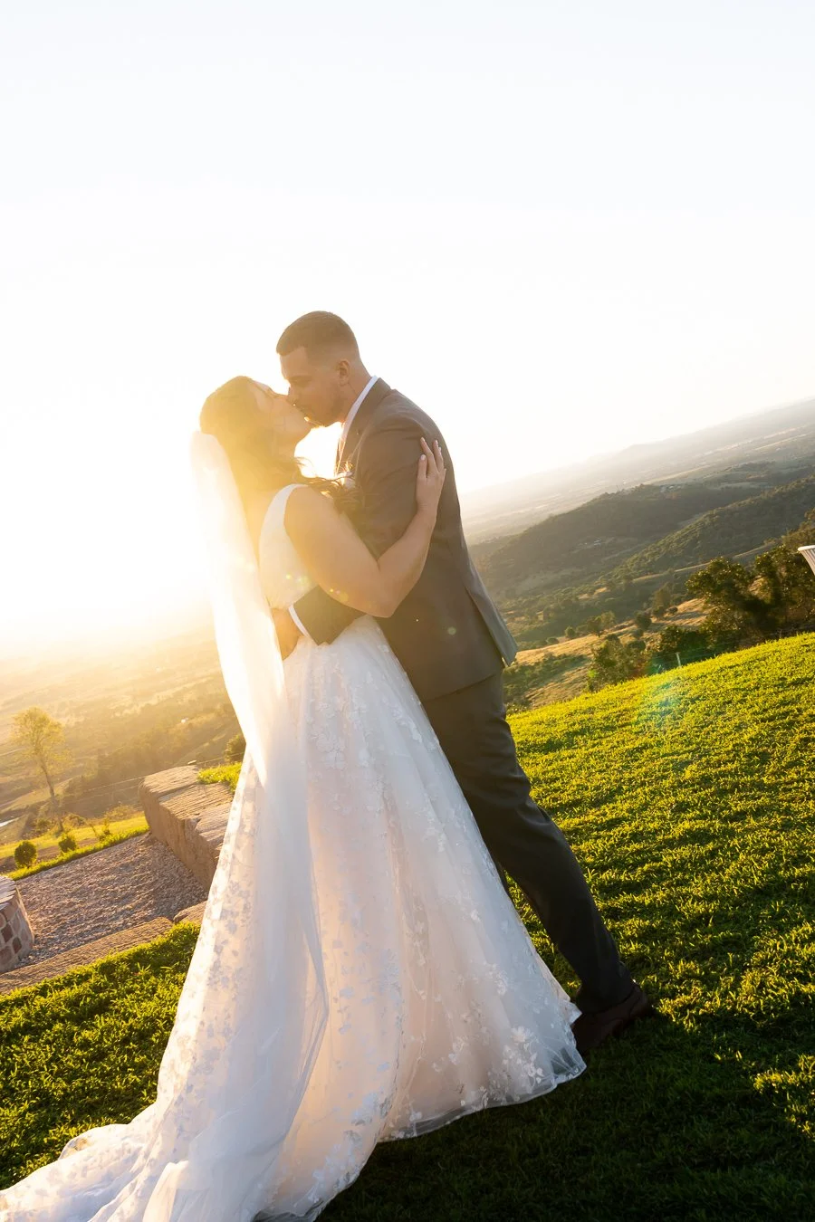 bride Chiarra and groom Ben kissing in a beautiful sunset
