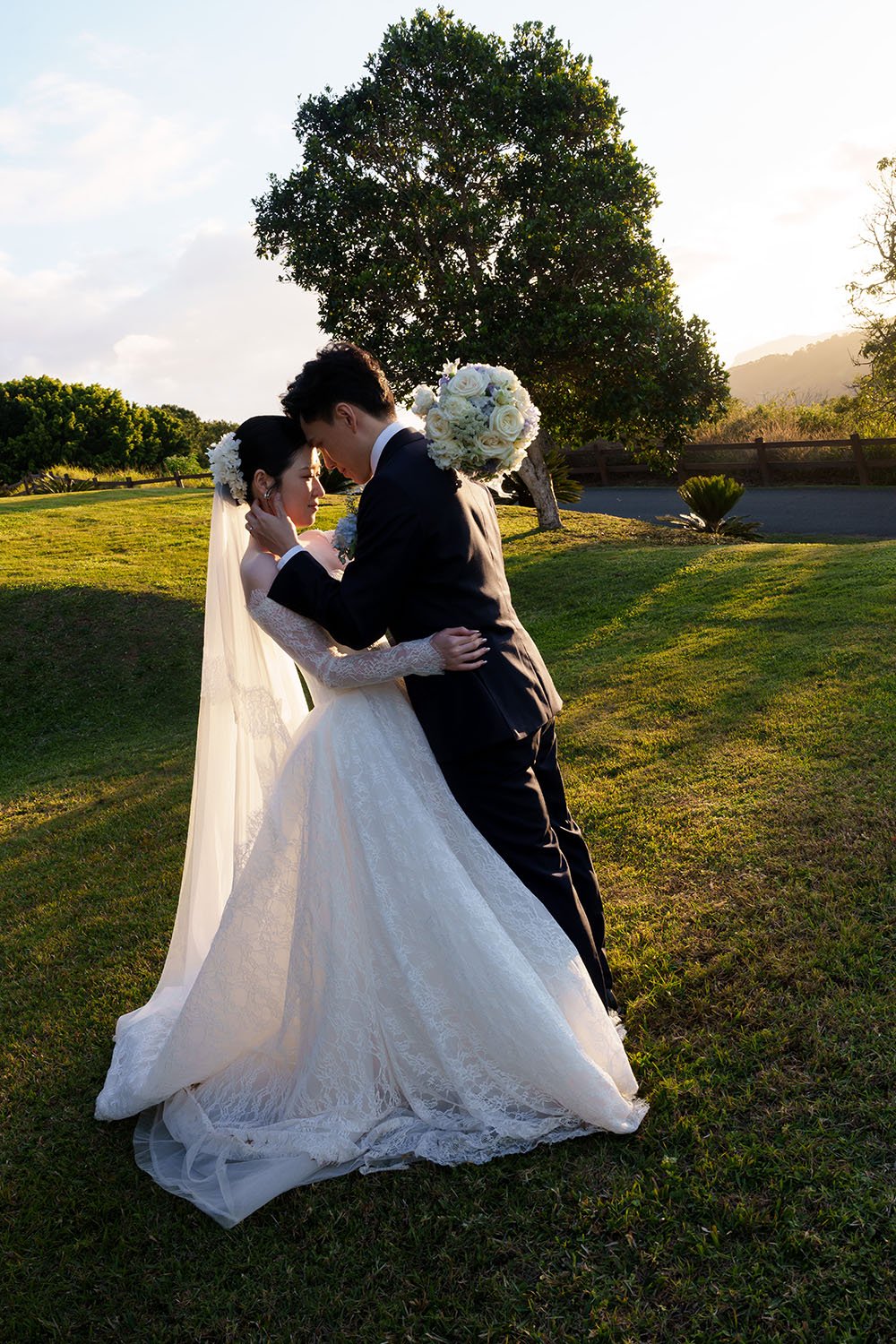 Michael and Lisa holding each other with her arm wraps around his neck with forehead toching