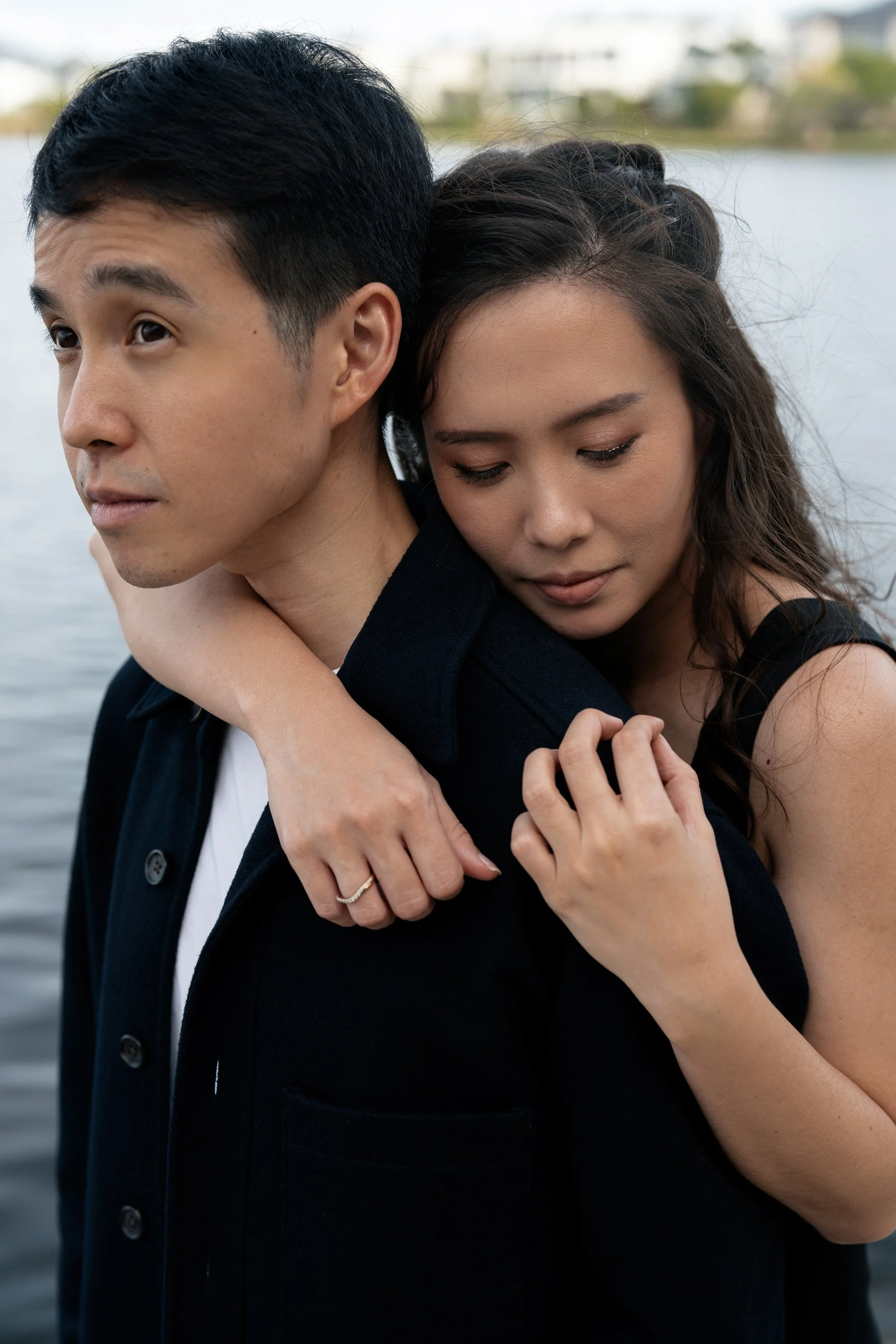 Krystel holding Paul's shoulder from back and shows the engagement ring in Emerald Lakes Village