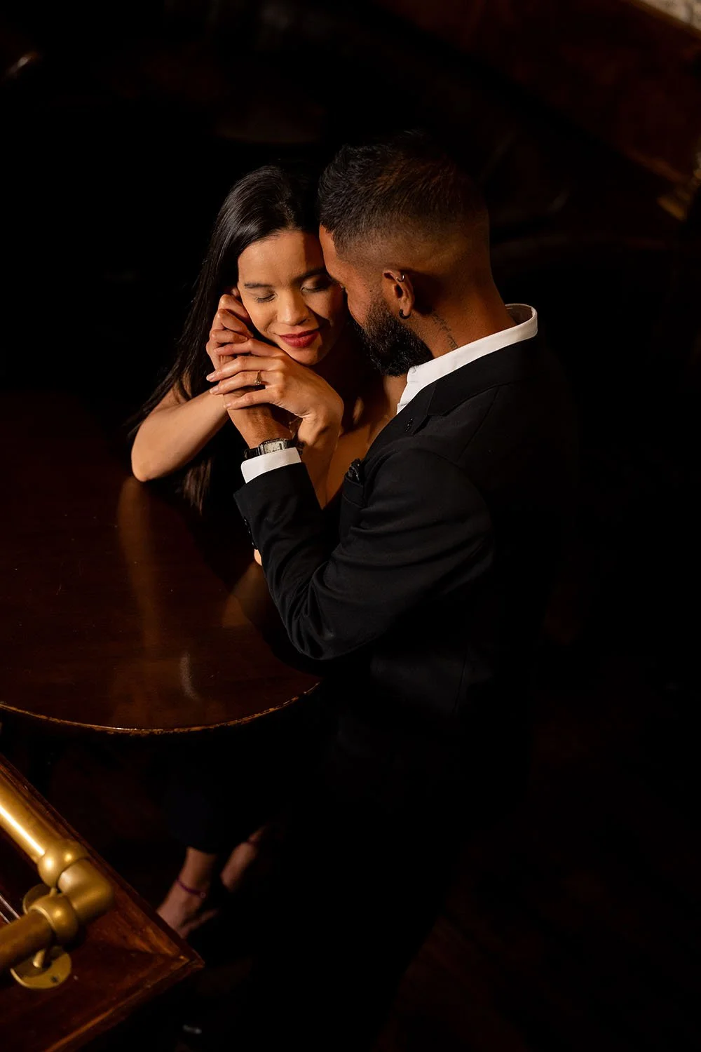Jasmin holding Jay’s hand gently against her face as Jay rests his forehead against hers, sharing an intimate moment.