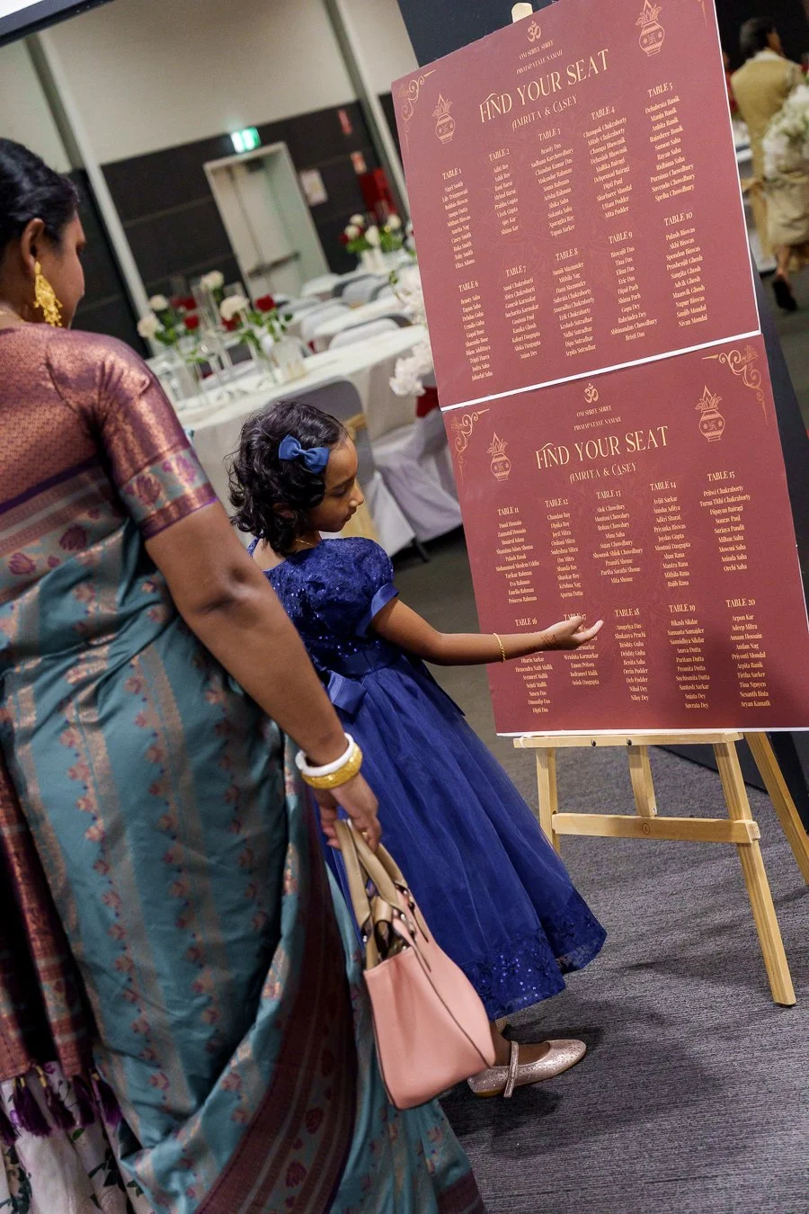 a girl look to the table order board to find her seat